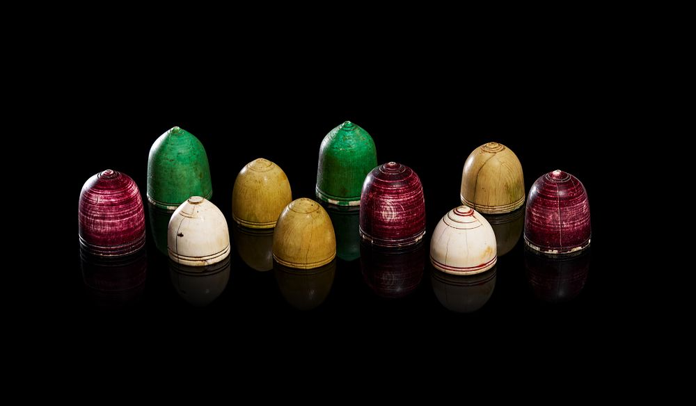 Lot 269: A COLLECTION OF INDIN PACHISI CHAUPAR COUNTERS NARADS BELL-SHAPED GAME PIECES, 18TH CENTURY