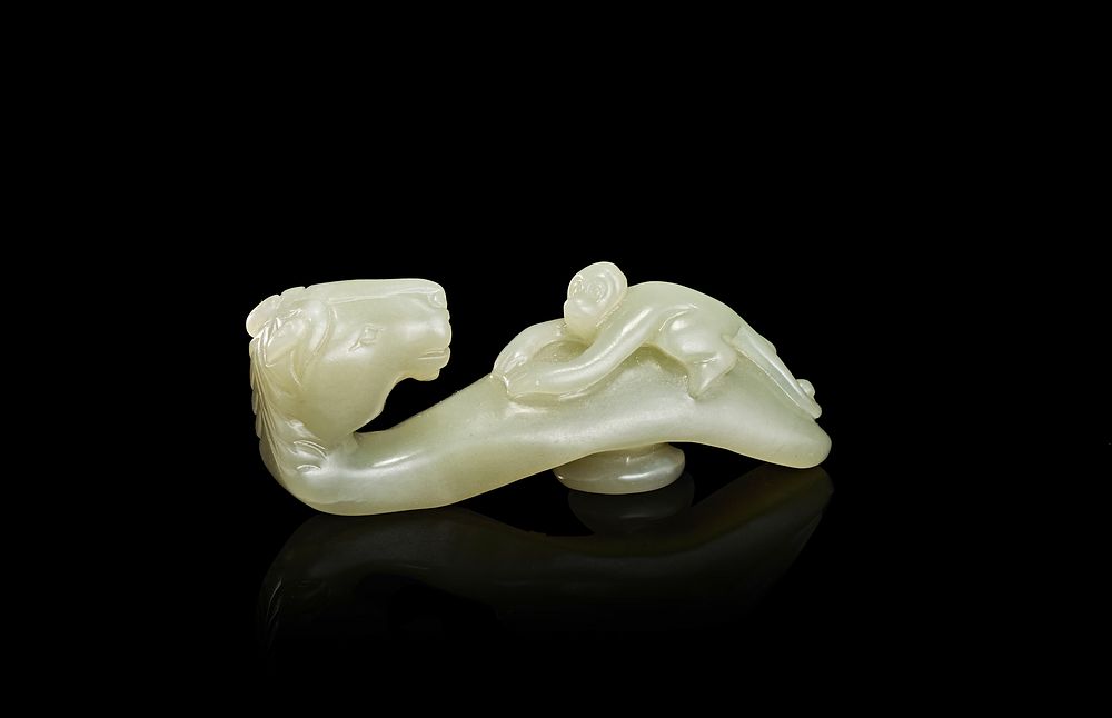 Lot 244: A CHINESE PALE CELADON JADE HORSE AND MONKEY BELT HOOK, QING DYNASTY (1644-1911)