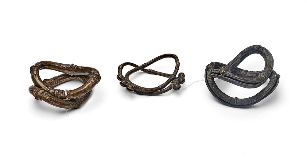 Lot 180: A THREE PAIRS OF INDIAN CAST COPPER ALLOY TRIBAL ANKLETS, SOUTH INDIA DECCAN, 17TH CENTURY