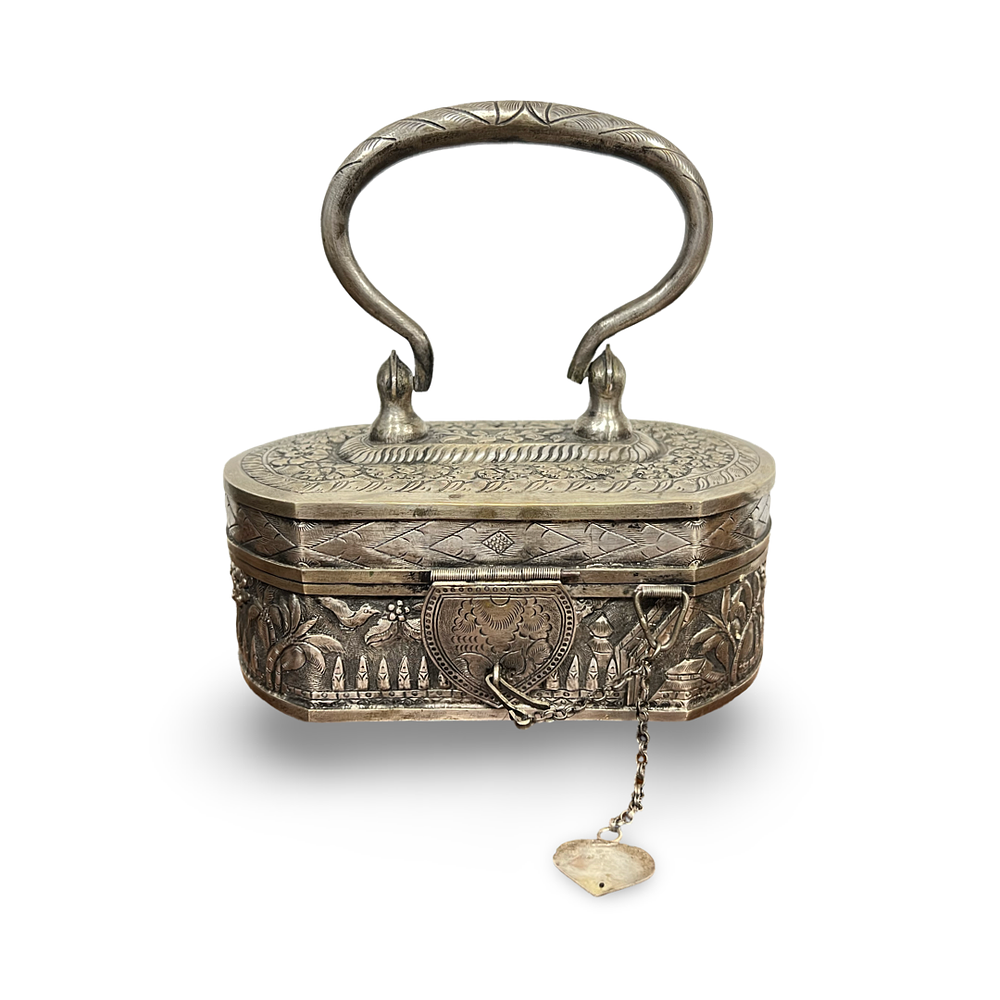 Lot 227: AN INDIAN WHITE METAL REPOUSSE HANDLED CLUTCH PURSE WITH LANDSCAPE MOTIFS