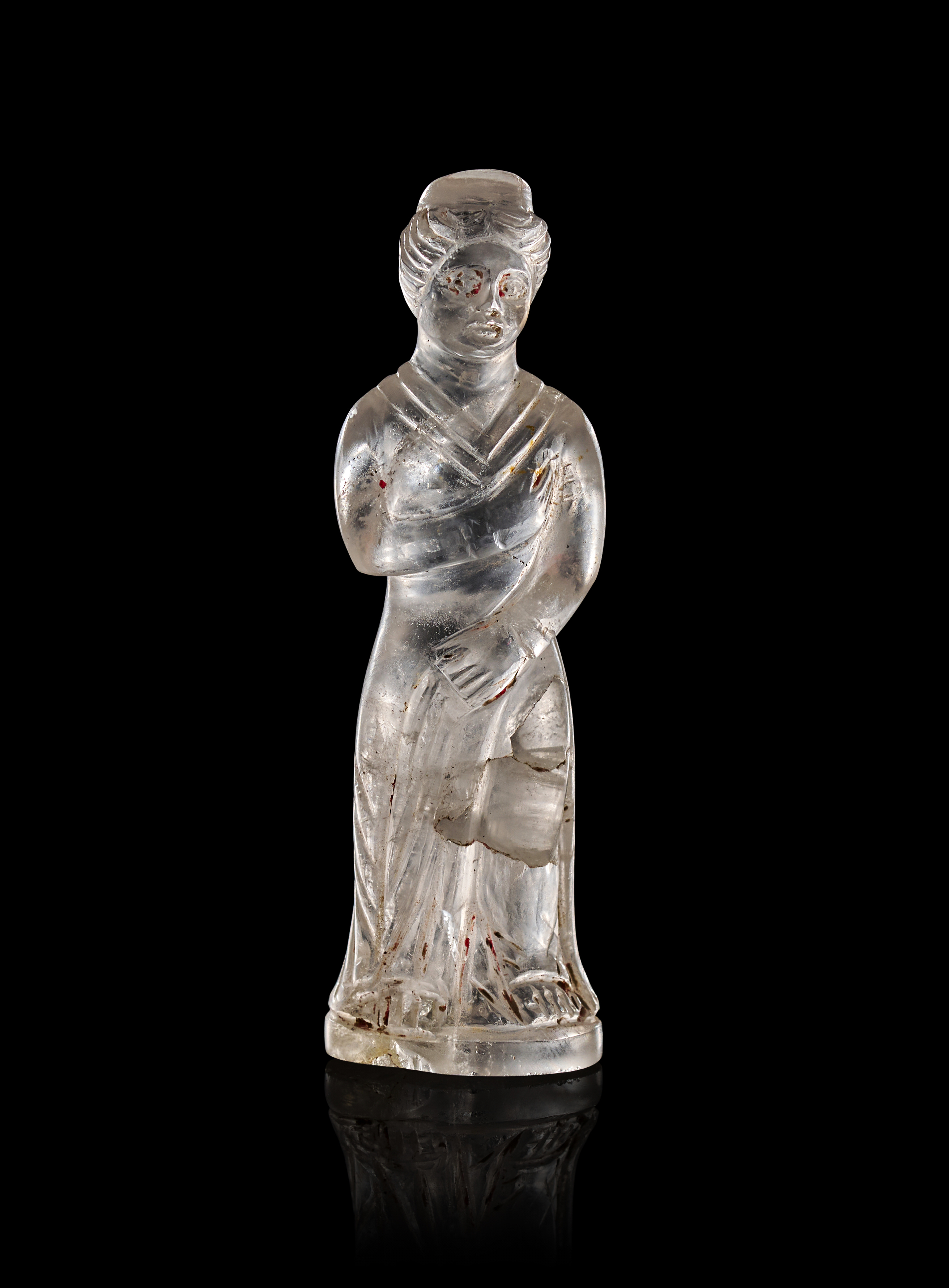 A ROMAN ROCK CRYSTAL FIGURE OF A FEMALE DEITY, CIRCA 1ST CENTURY A.D.