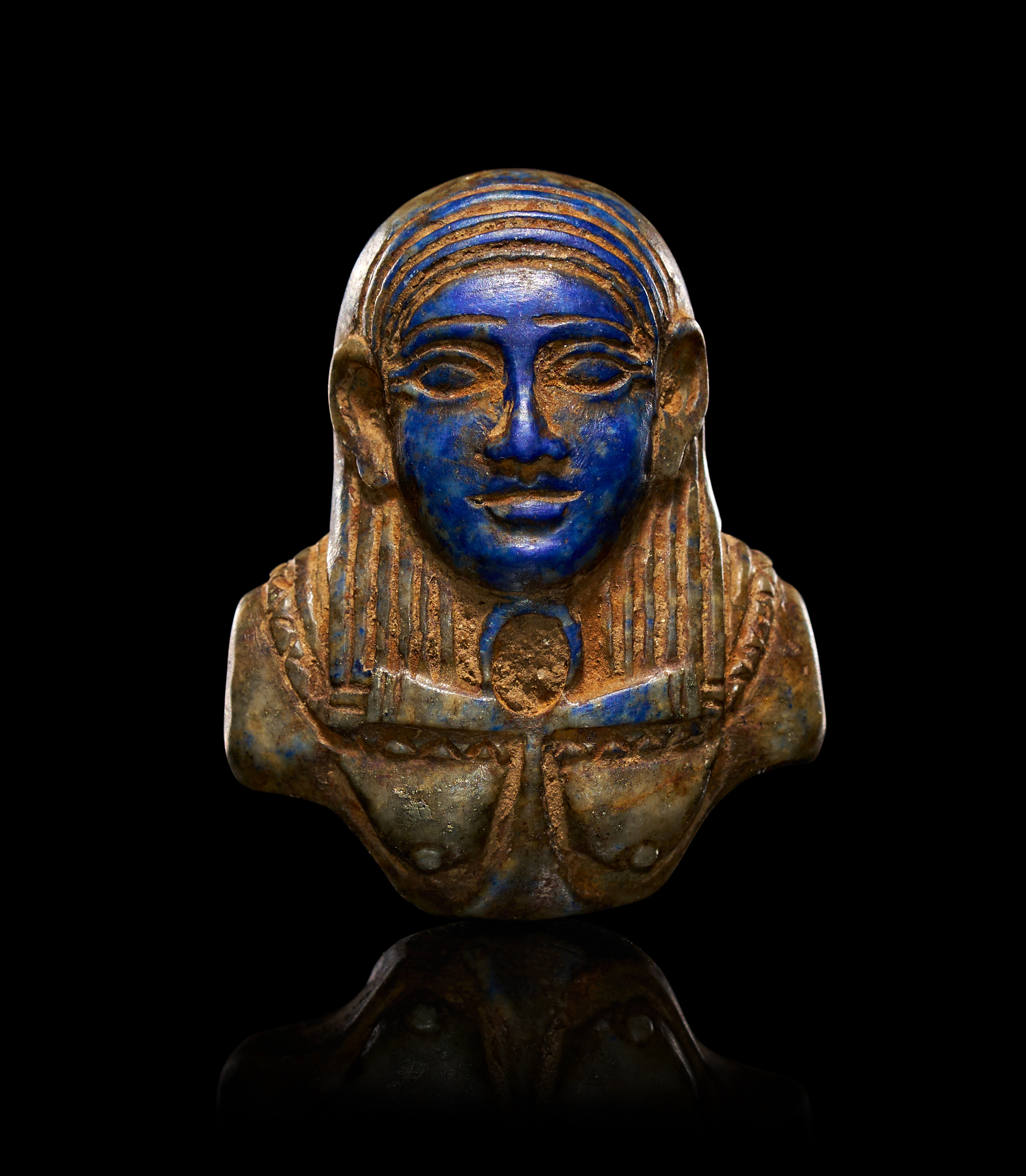 A LAPIS LAZULI EGYPTIAN PENDANT DEPICTING THE GODDESS HATHOR, LATE PERIOD-PTOLEMAIC PERIOD, CIRCA 664-30 B.C.