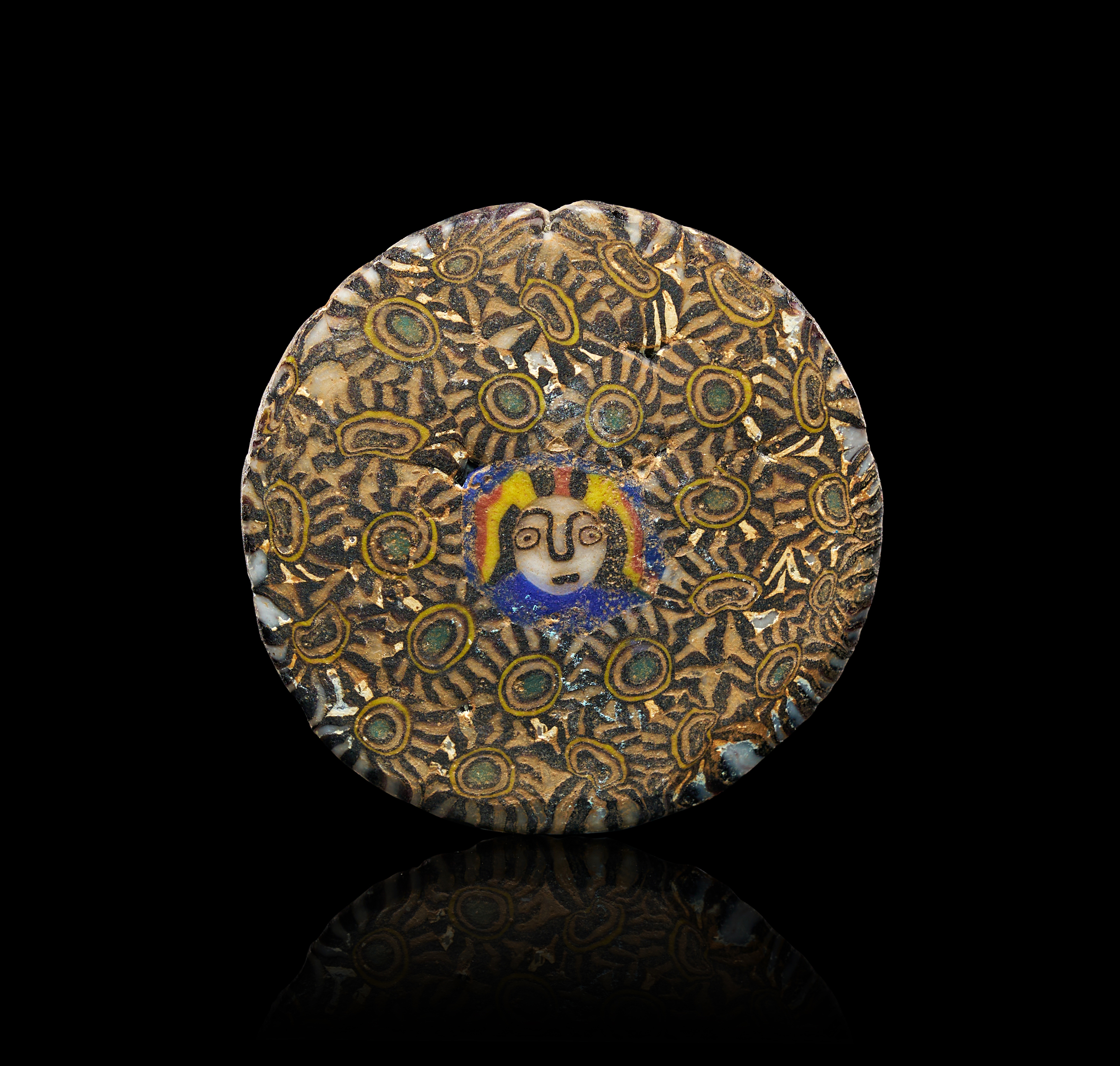 A DOUBLE SIDED MOSAIC GLASS GAMING PIECE, PROBABLY ROMAN 1ST - 2ND CENTURY A.D.