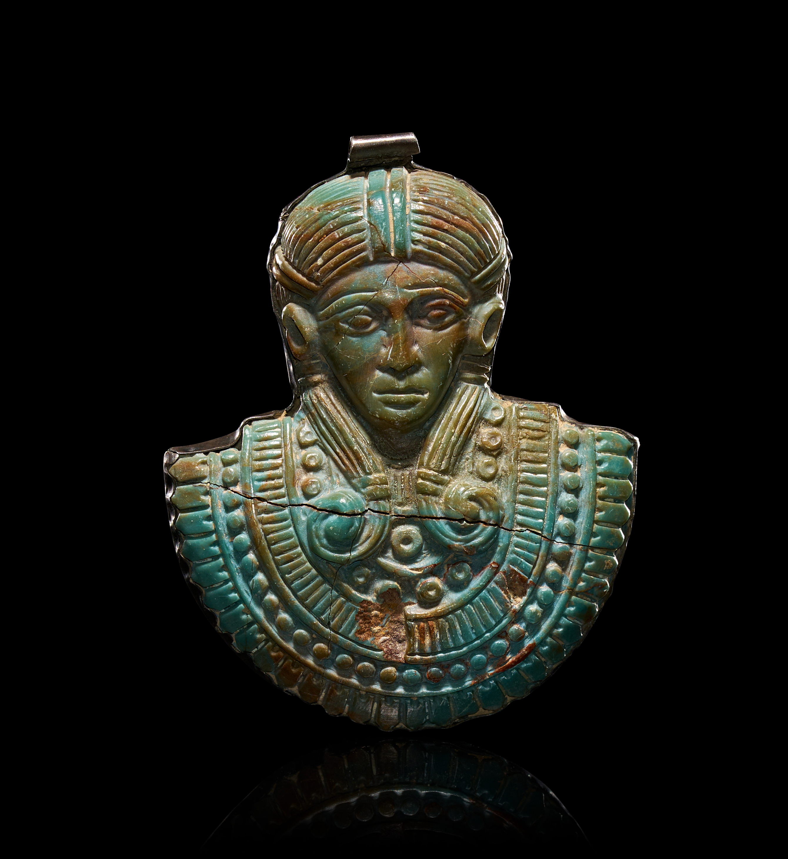 AN EGYPTIAN TURQUOISE STONE PENDANT OF A GODDESS IN SILVER-TONED MOUNT, THIRD INTERMEDIATE PERIOD, CIRCA 1069-702 B.C.