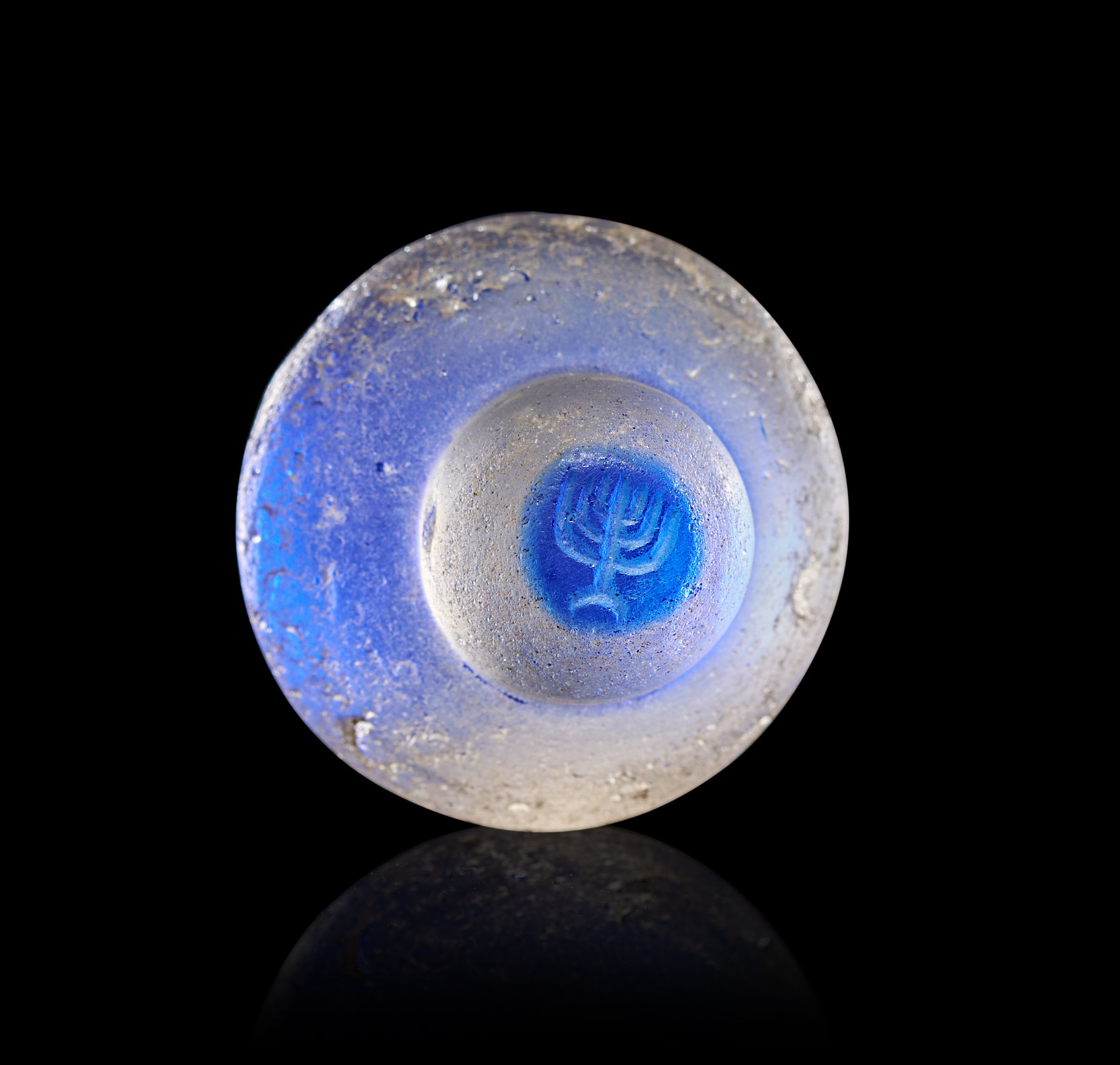 A BYZANTINE STAMPED GLASS PILGRIM WITH MENORAH, LATE 6TH - EARLY 7TH CENTURY A.D.