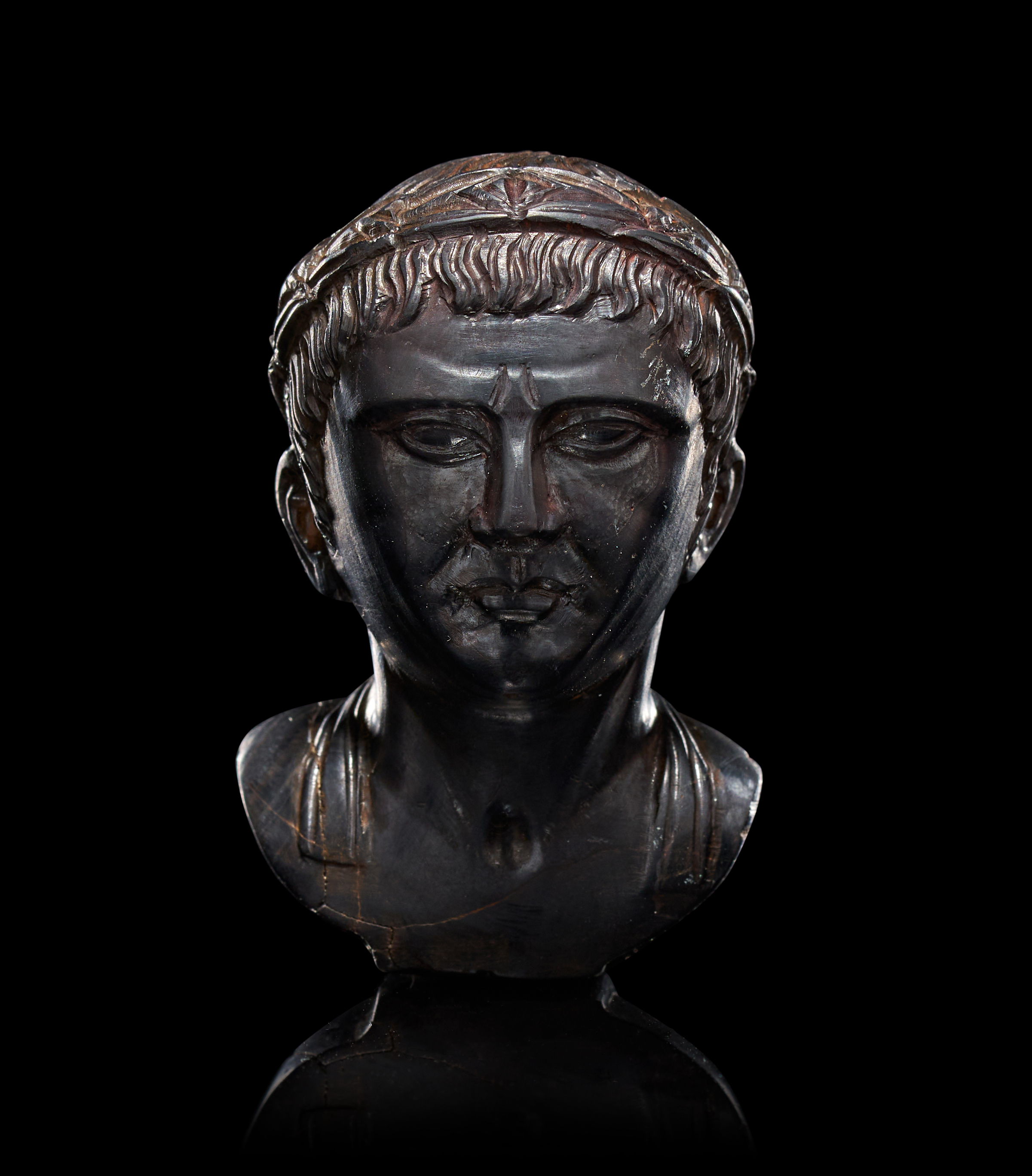 A ROMAN CARVED HEMATITE PORTRAIT BUST OF GERMANICUS, CIRCA 3RD CENTURY
