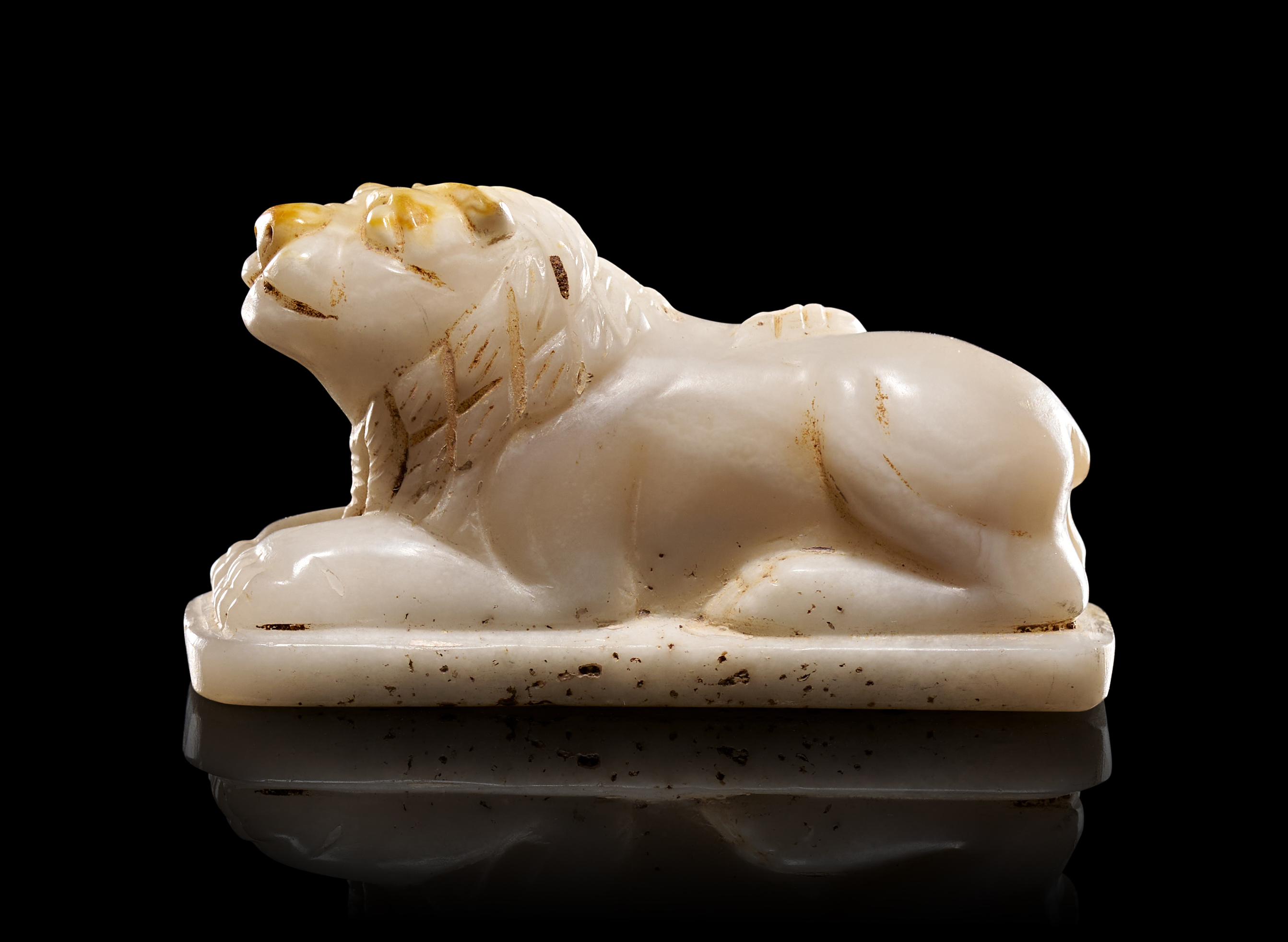 AN AGATE FIGURE OF A SEATED LION, EASTERN GREEK PERIOD, 2ND - 3RD CENTURY B.C.