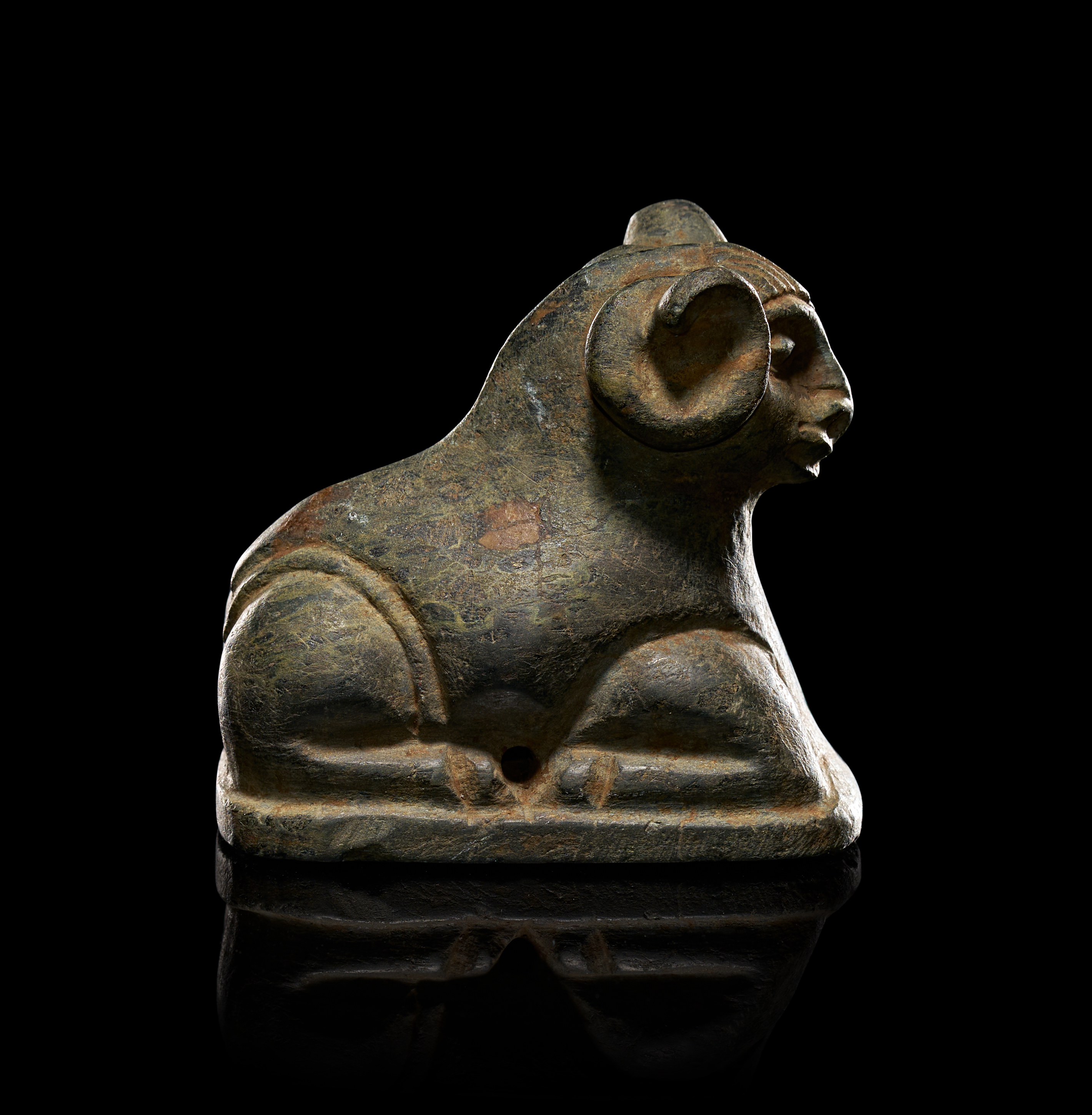 A STEATITE STONE IN THE FORM OF A RECUMBENT RAM, PERSIAN PERIOD 500 - 400 B.C.