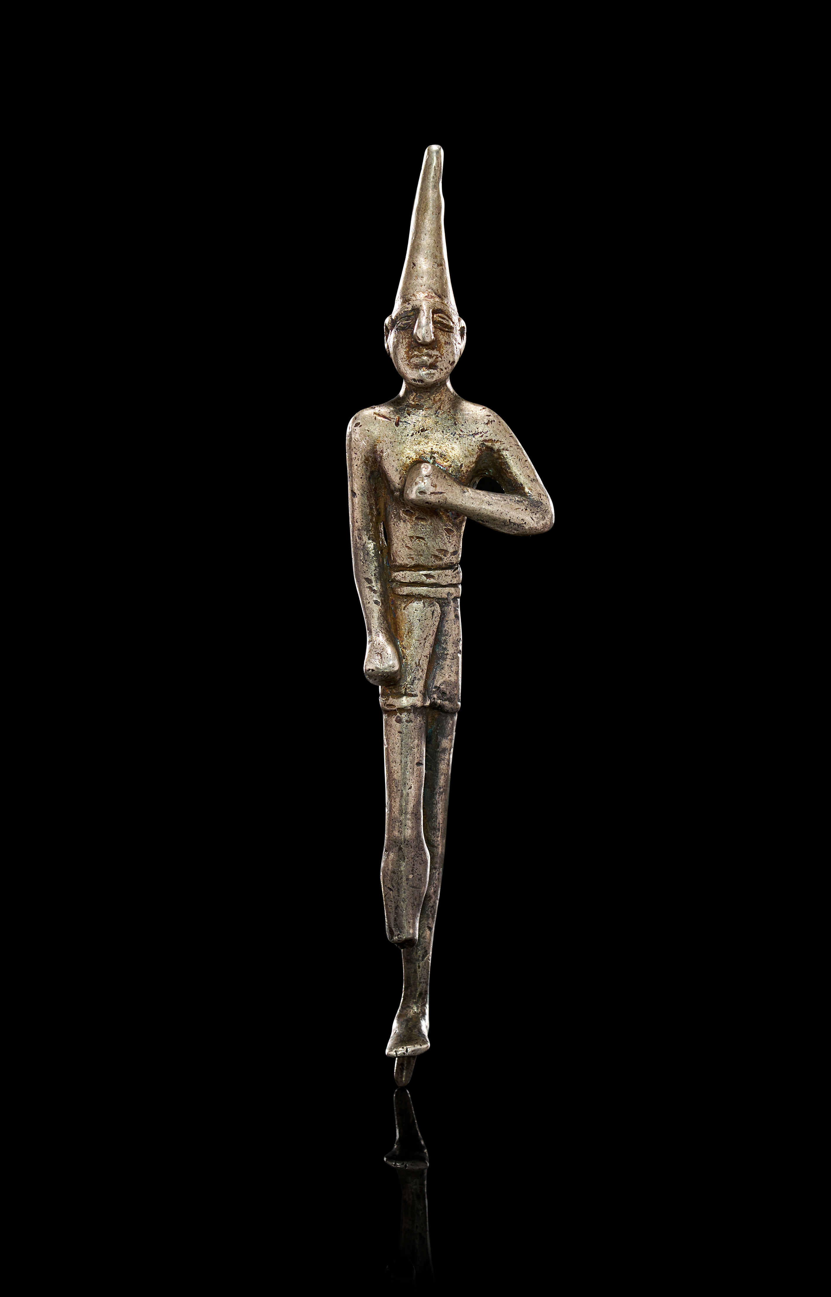 A SILVER STANDING FIGURINE OF A DEITY/DIGNITARY, HITTITE PERIOD/ANCIENT ANATOLIA, CIRCA 1500 B.C.