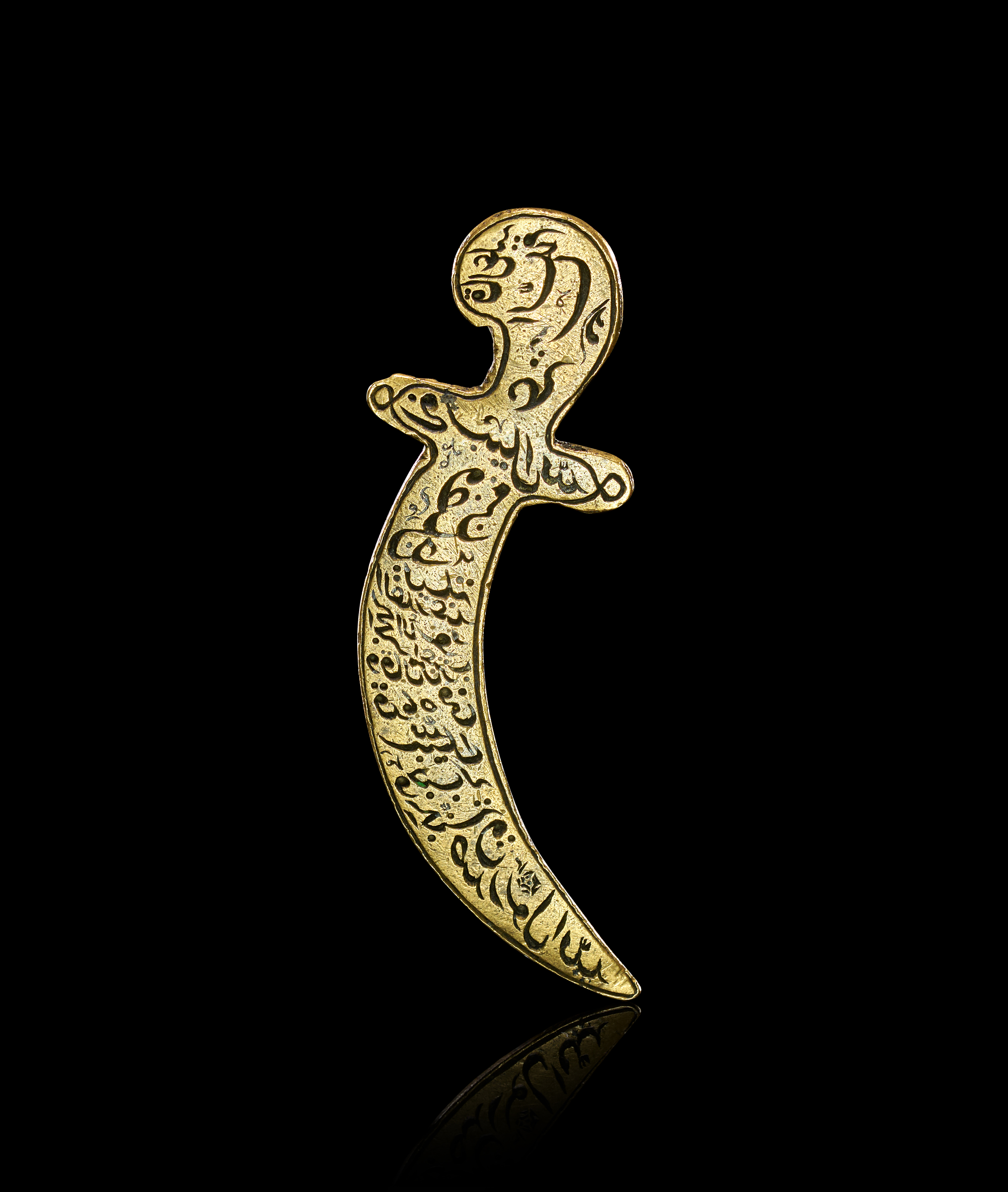 A PERSIAN ENGRAVED TALISMANIC BRASS BROOCH IN THE FORM OF A DAGGER, QAJAR, 19TH CENTURY