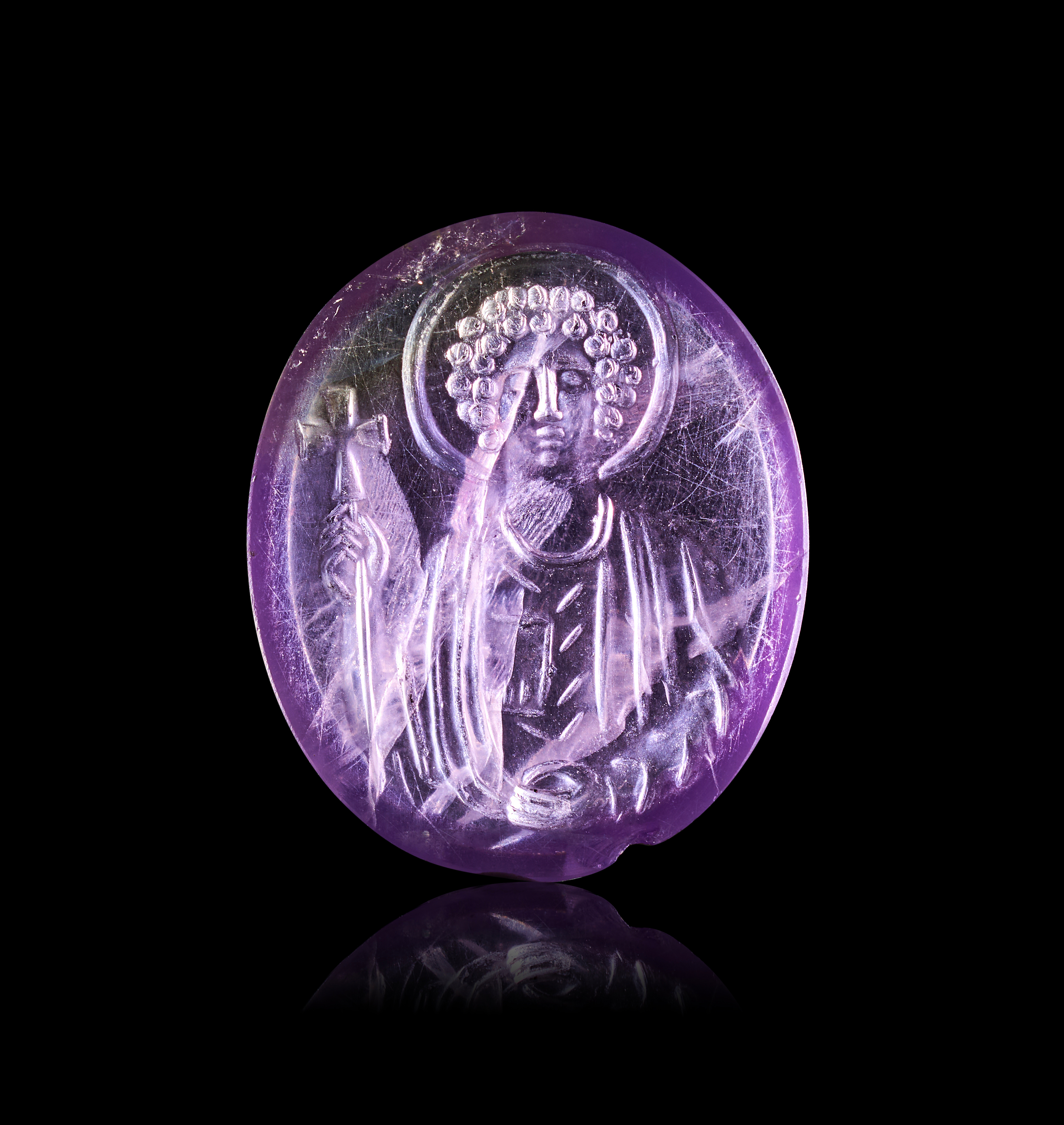 A MIDDLE BYZANTINE AMETHYST INTAGLIO DEPICTING A HOLY FIGURE, 10TH - 12TH CENTURY