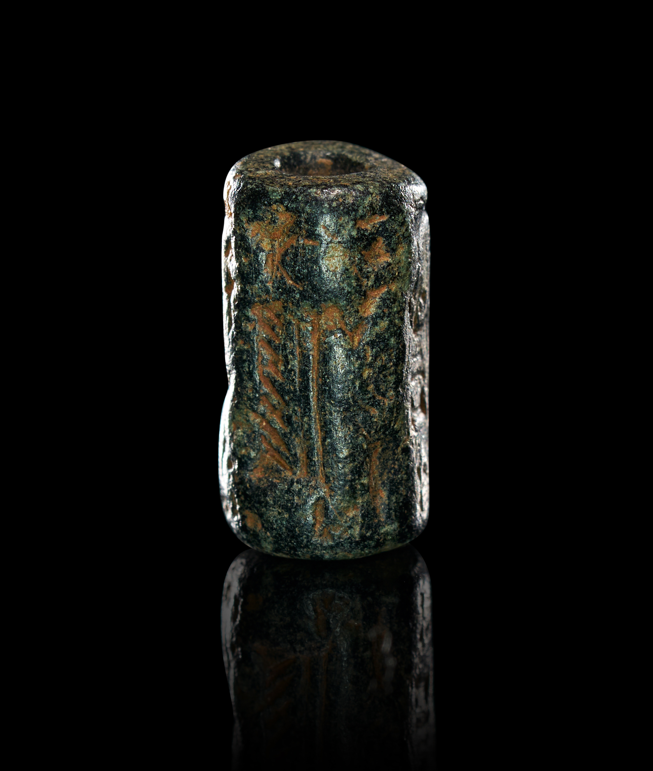 AN ANCIENT NEAR EASTERN STONE CYLINDER SEAL WITH CUNEIFORM INSCRIPTION