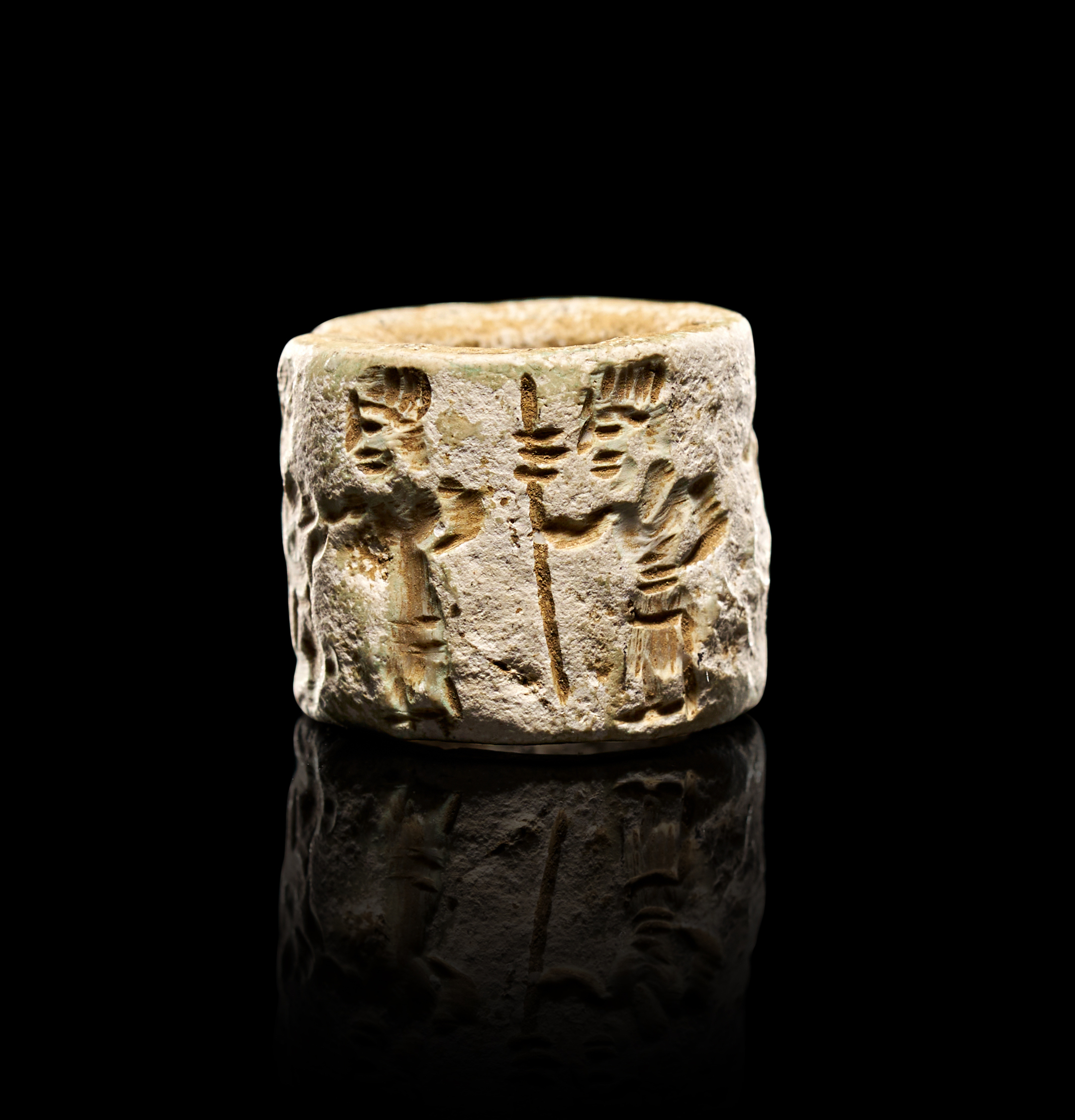 A NEAR EASTERN MITANNI FAIENCE CYLINDER SEAL WITH FIGURES AND CUNEIFORM