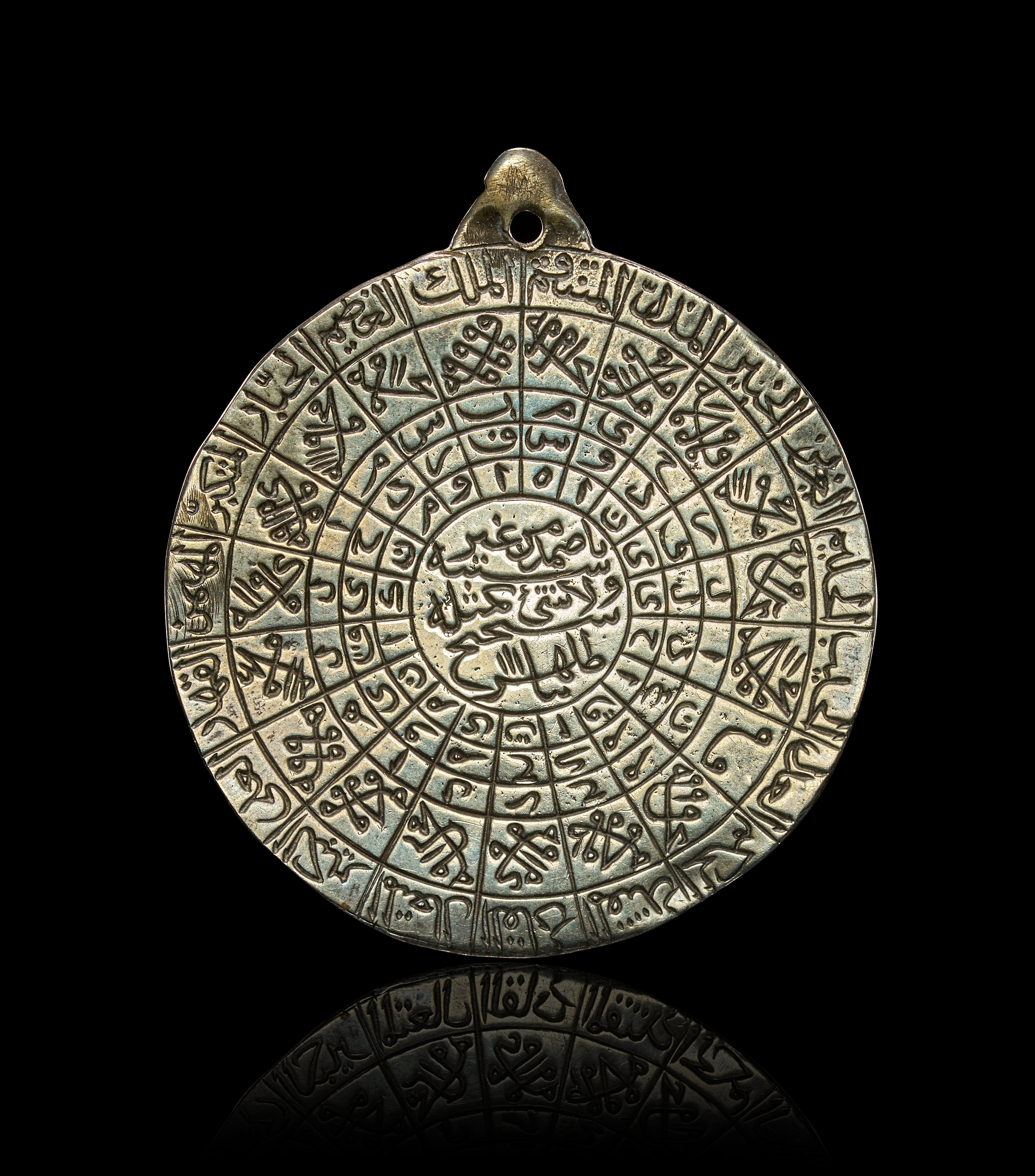 AN ENGRAVED SILVER SAFAVID ISLAMIC TALISMANIC SUFI PENDANT WITH AYAT AL-KURSI AND ASMA UL-HUSNA, PERSIA, 17TH CENTURY