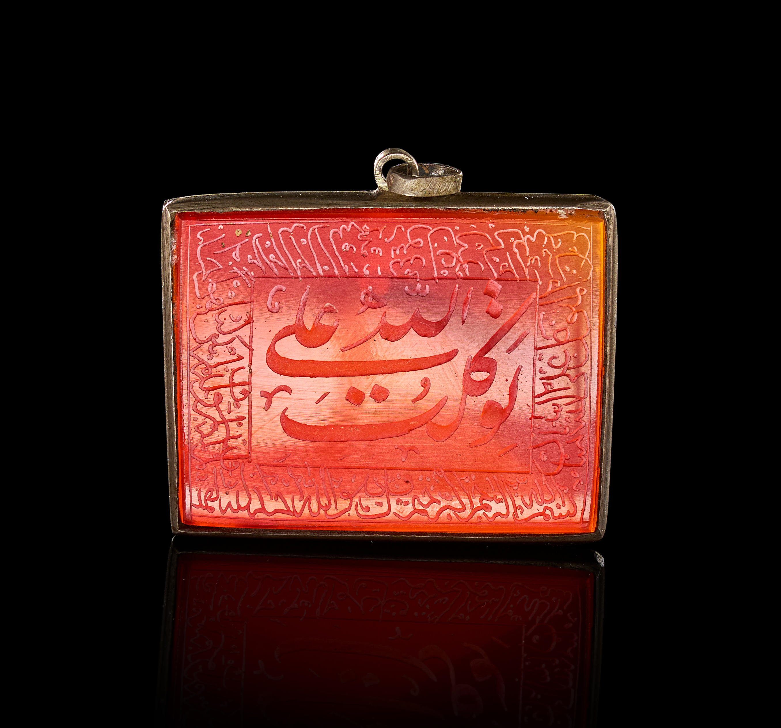 A QAJAR SILVER MOUNTED INSCRIBED CARNELIAN TALISMANIC PENDANT, PERSIA, 19TH CENTURY