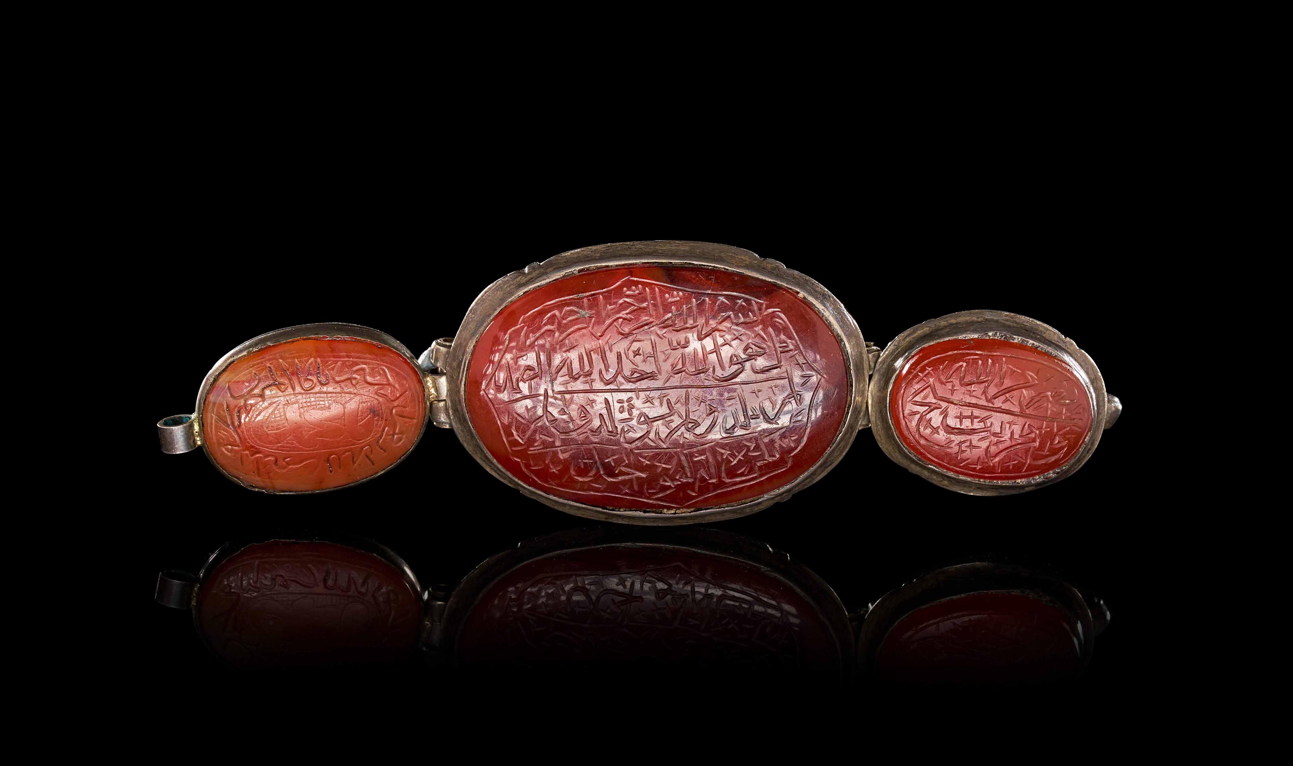 A PERSIAN QAJAR SILVER AND CARNELIAN CALLIGRAPHIC TRIPLE-PENDANT BAZUBAND, , 19TH CENTURY