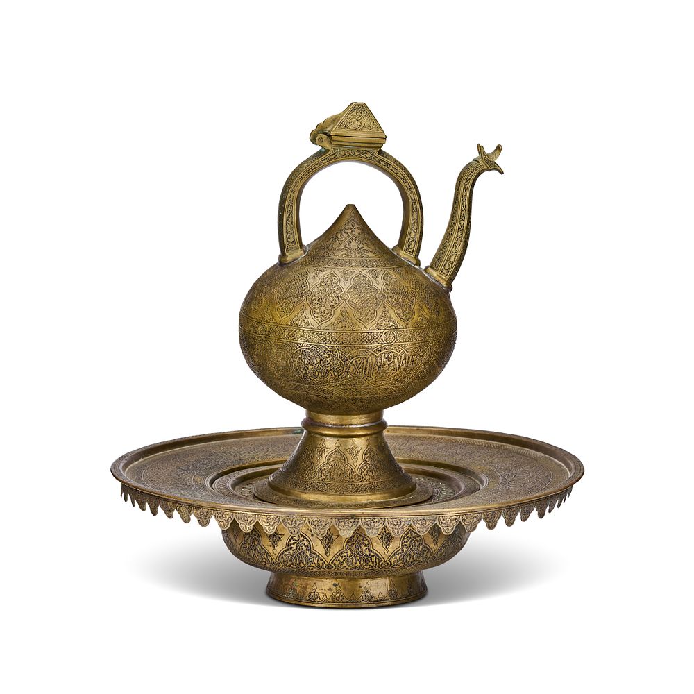 Lot 251: A PERSIAN ENGRAVED BRASS EWER AND BASIN SET, LATE 19TH CENTURY - EARLY 20TH CENTURY