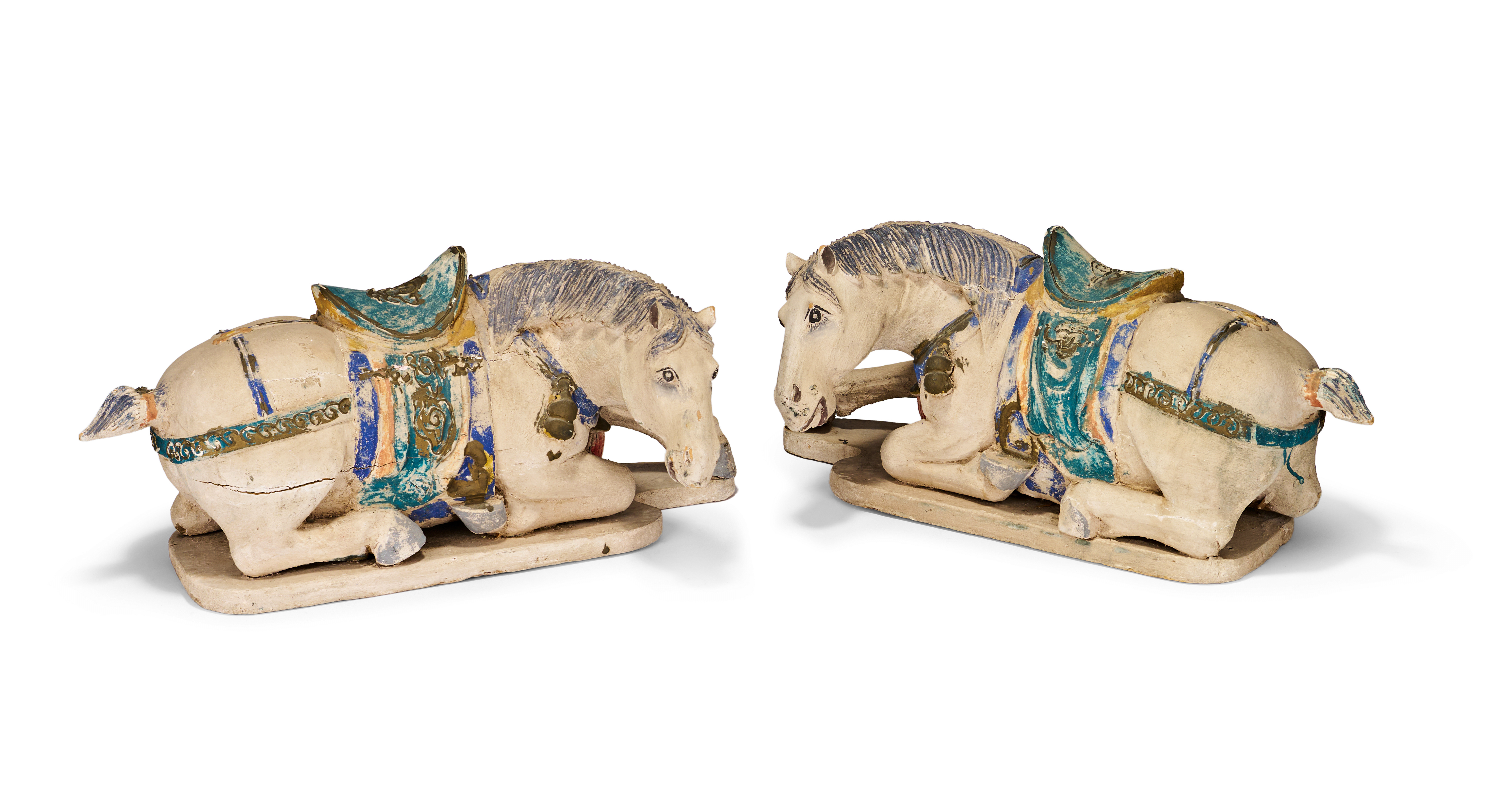 A PAIR OF INDIAN CARVED WOOD AND PAINTED FIGURES OF RECUMBENT HORSES, 19TH - 20TH CENTURY