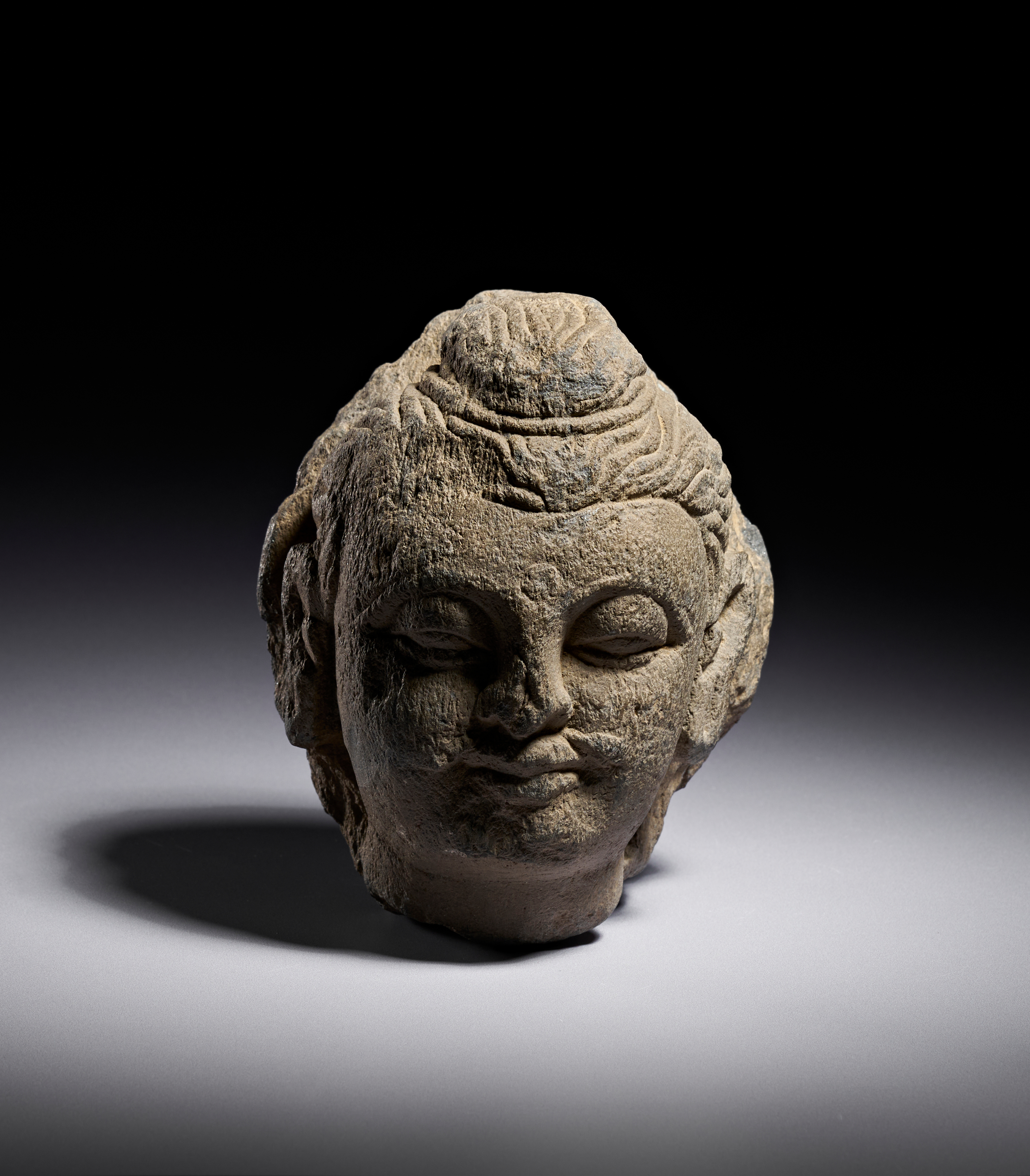A GANDHARAN GREY SCHIST HEAD OF BUDDHA, 2ND - 4TH CENTURY A.D