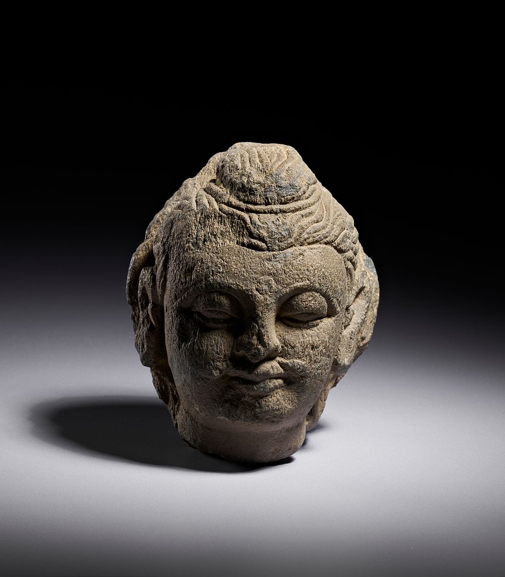 Lot 227: A GANDHARAN GREY SCHIST HEAD OF BUDDHA, 2ND - 4TH CENTURY A.D