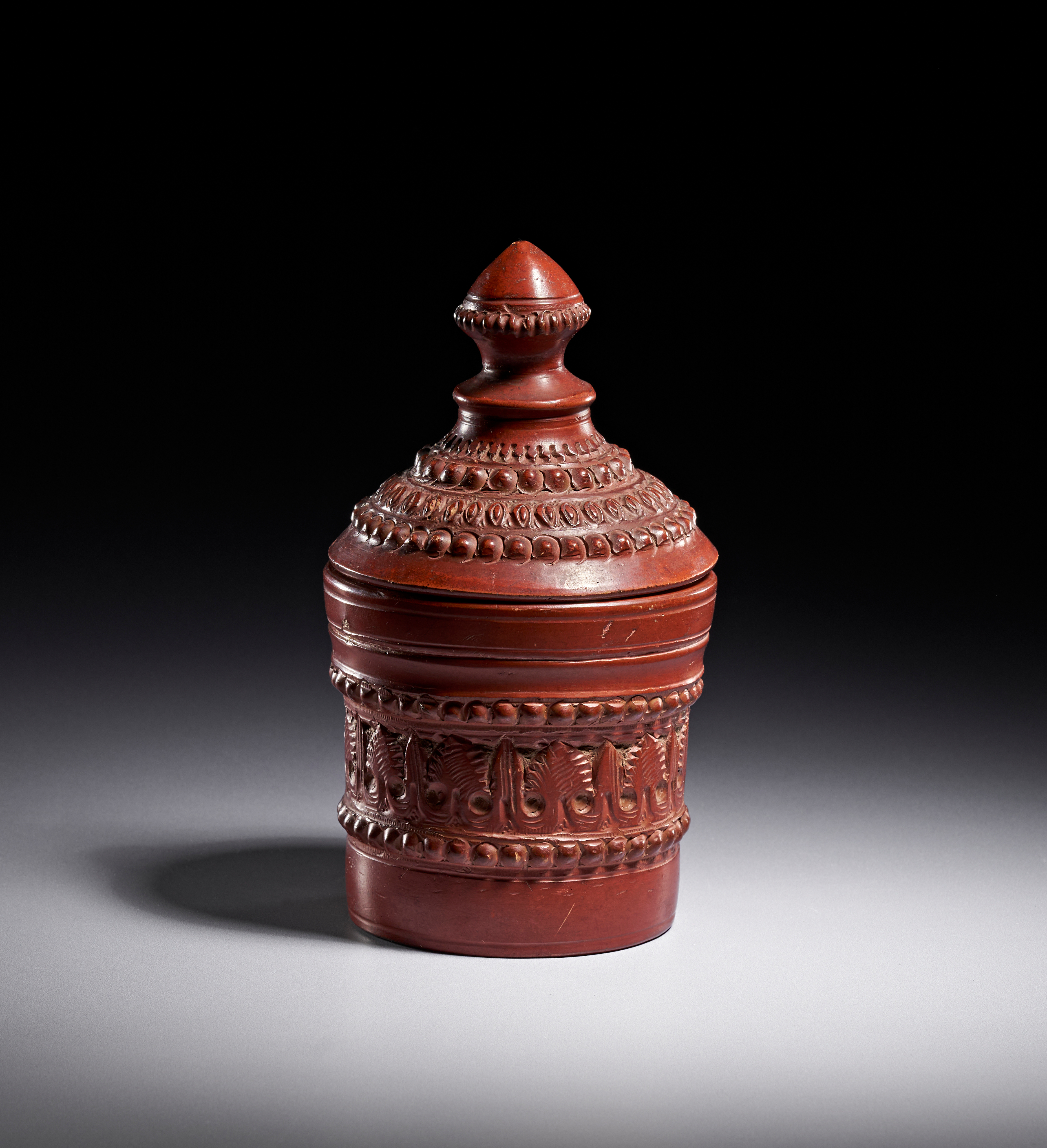 A TOPHANE RELIEF-DECORATED RED STONEWARE LIDDED JAR, TURKEY, 20TH CENTURY