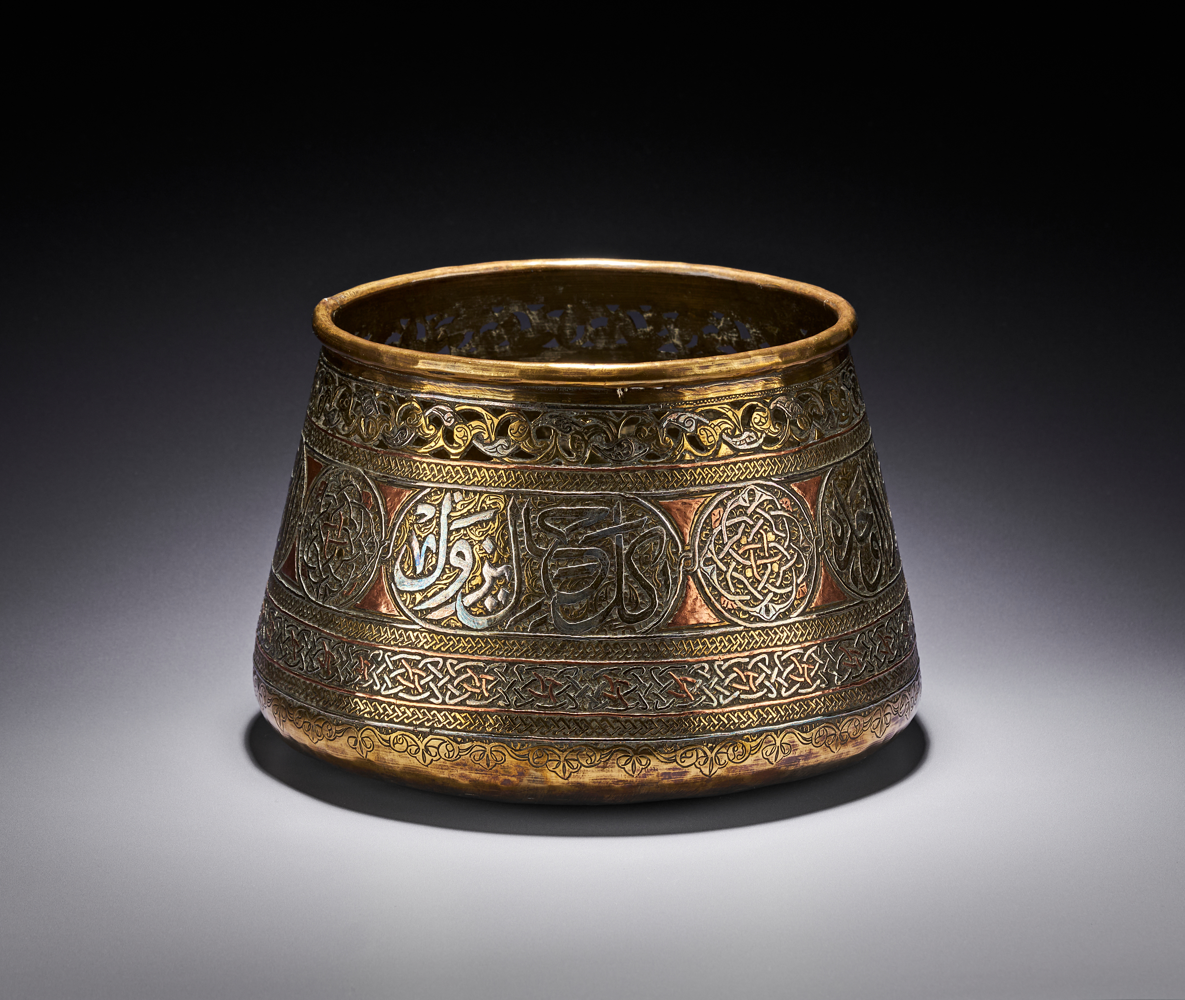 A MAMLUK REVIVAL SILVER AND COPPER INLAID BRASS BASIN, EGYPT OR SYRIA, 19TH - 20TH CENTURY