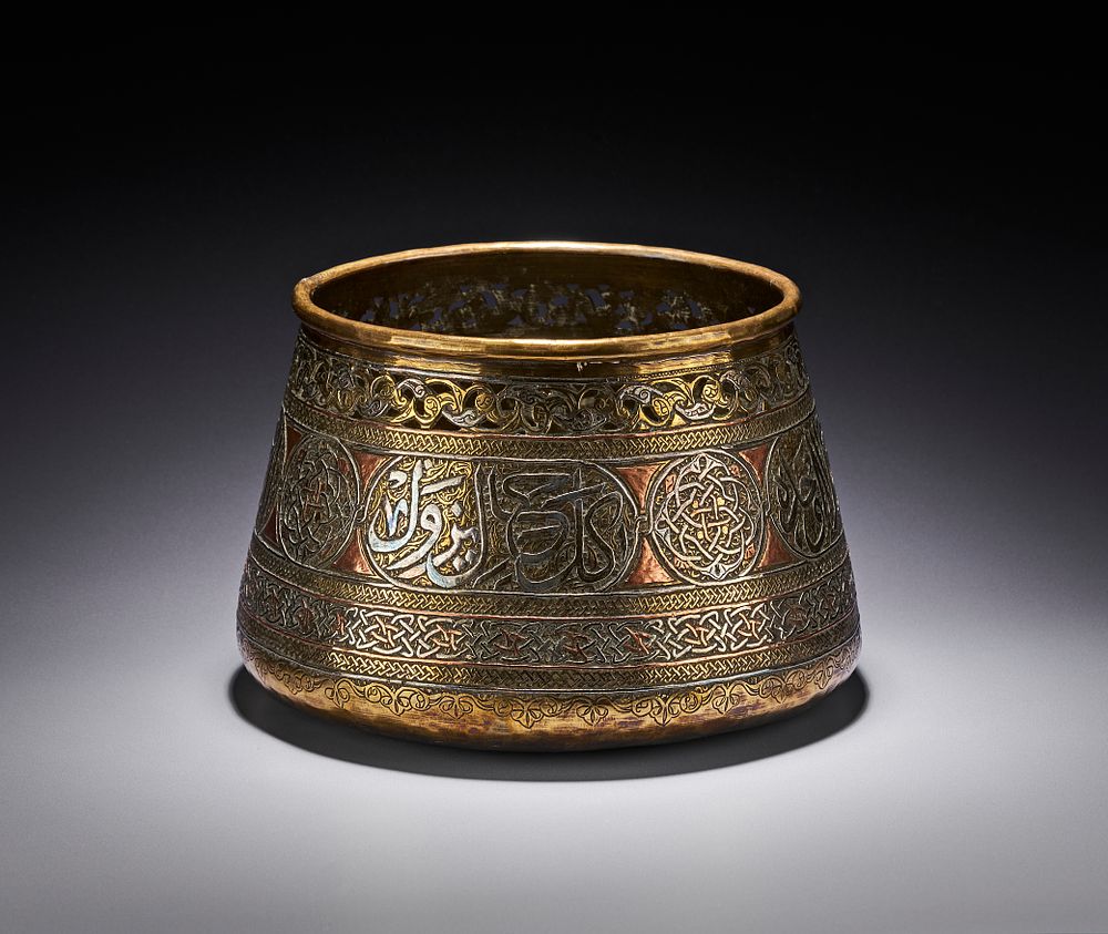 Lot 257: A MAMLUK REVIVAL SILVER AND COPPER INLAID BRASS BASIN, EGYPT OR SYRIA, 19TH - 20TH CENTURY