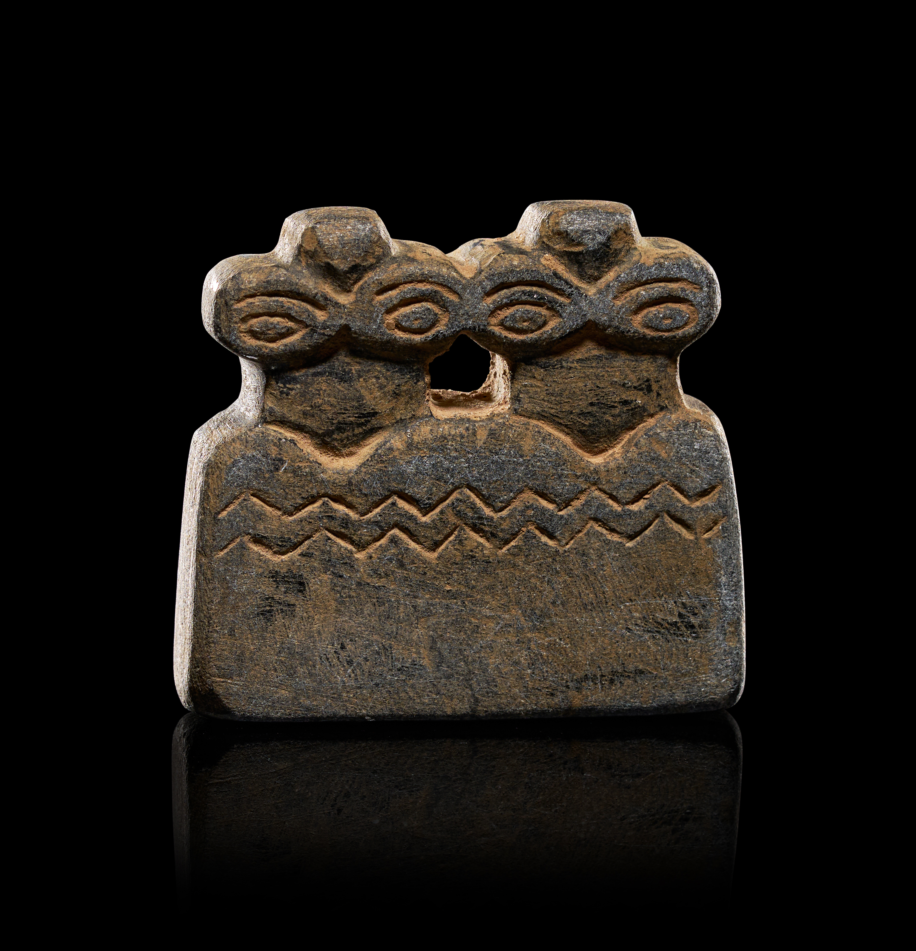 A TELL BRAK CARVED STONE DOUBLE-HEADED EYE IDOL, CIRCA 3500-3300 B.C.