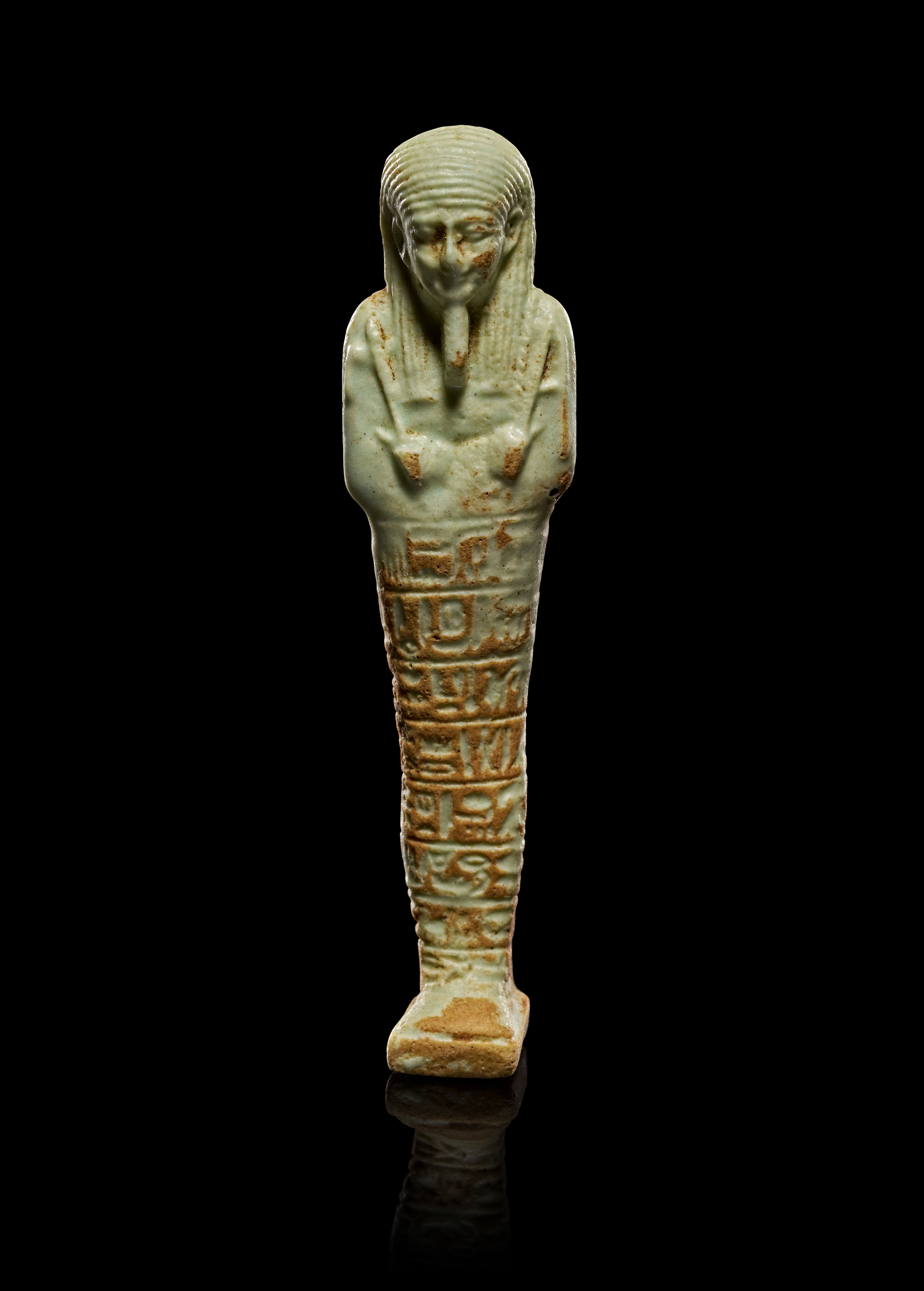 AN EGYPTIAN LATE PERIOD PALE GREEN FAIENCE SHABTI, LATE PERIOD CIRCA 664–332 BCE