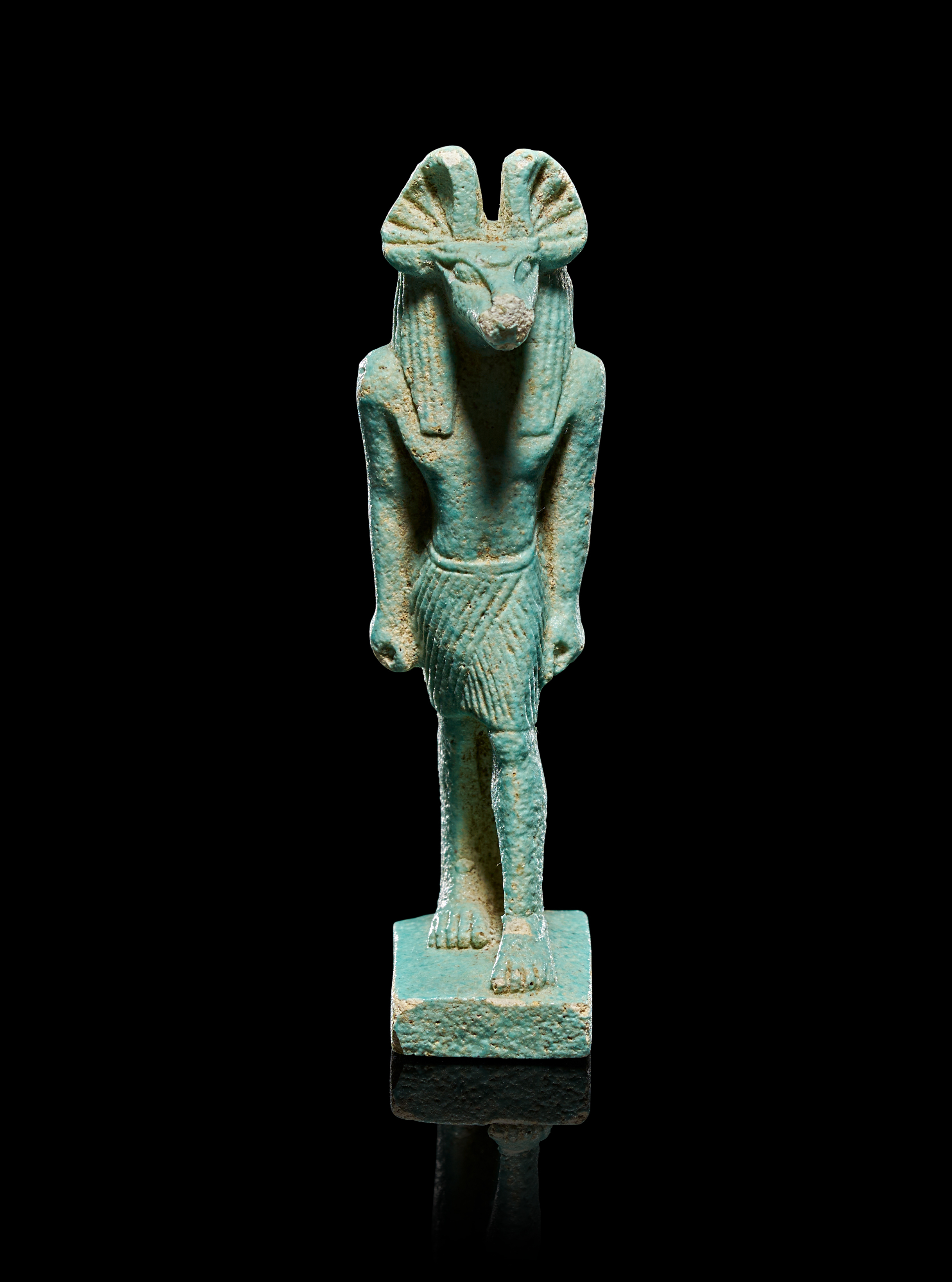 AN EGYPTIAN TURQUOISE FAIENCE AMULET OF ANUBIS, LATE PERIOD - PTOLEMAIC PERIOD, CIRCA 664-30 BC