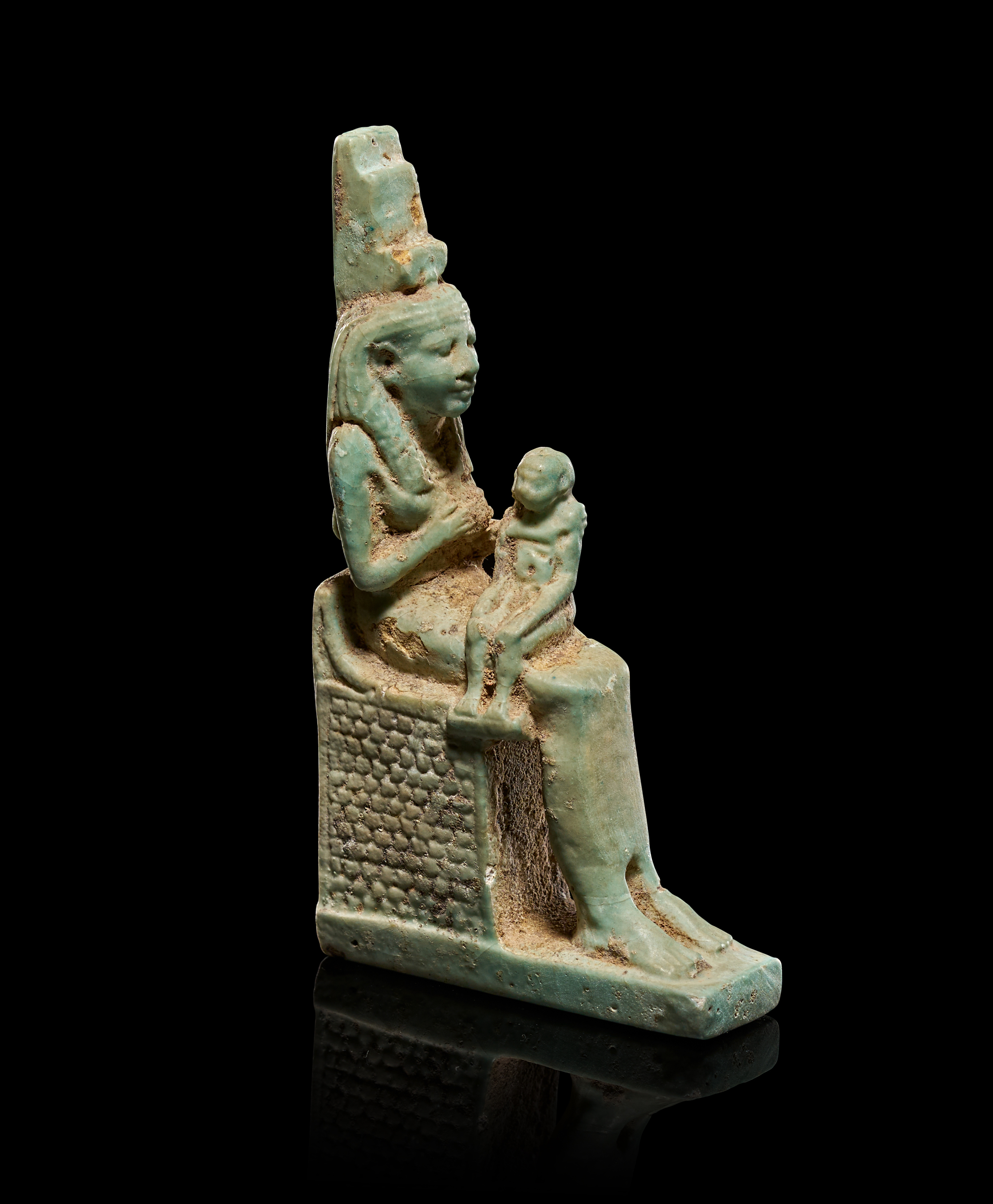AN EGYPTIAN TURQUOISE FAIENCE FIGURE OF ISIS WITH HORUS, PTOLEMAIC PERIOD, 304-30 B.C.