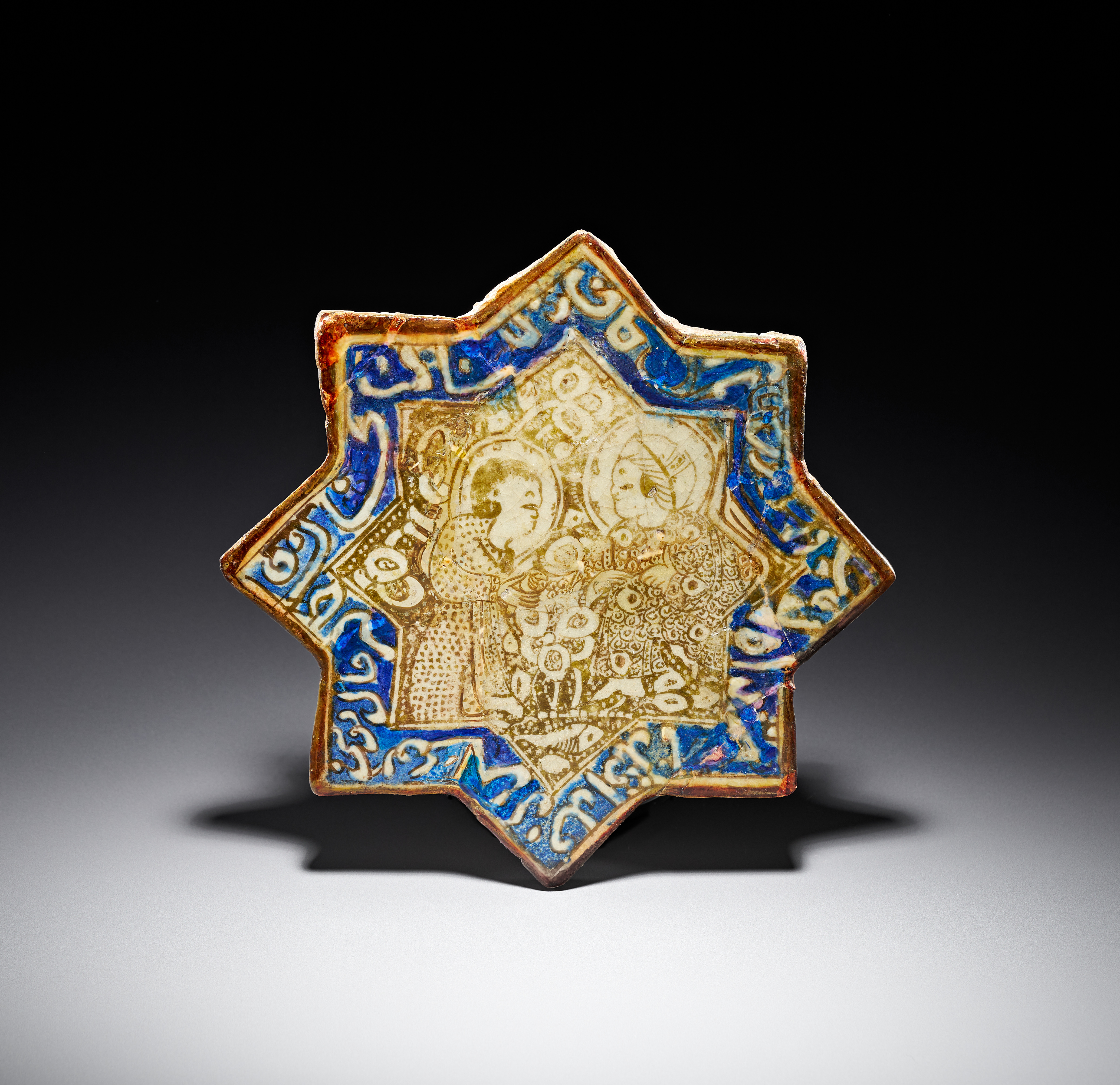 AN ILKHANID LUSTRE AND COBALT BLUE FRITWARE STAR TILE, LATE 13TH TO EARLY 14TH CENTURY