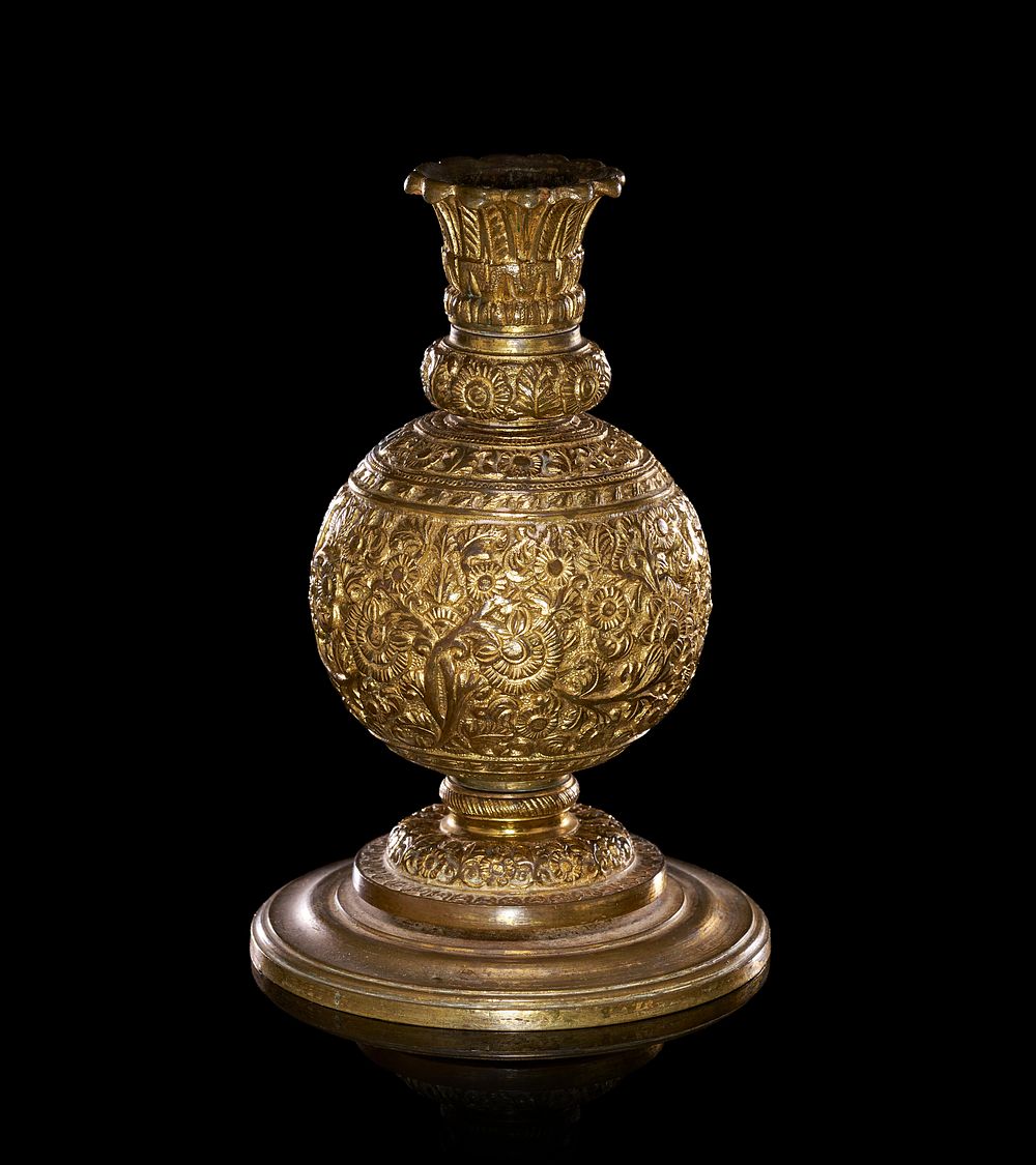 Lot 230: A REPOUSSE GILT METAL ANGLO INDIAN CANDLESTICK, 19TH CENTURY