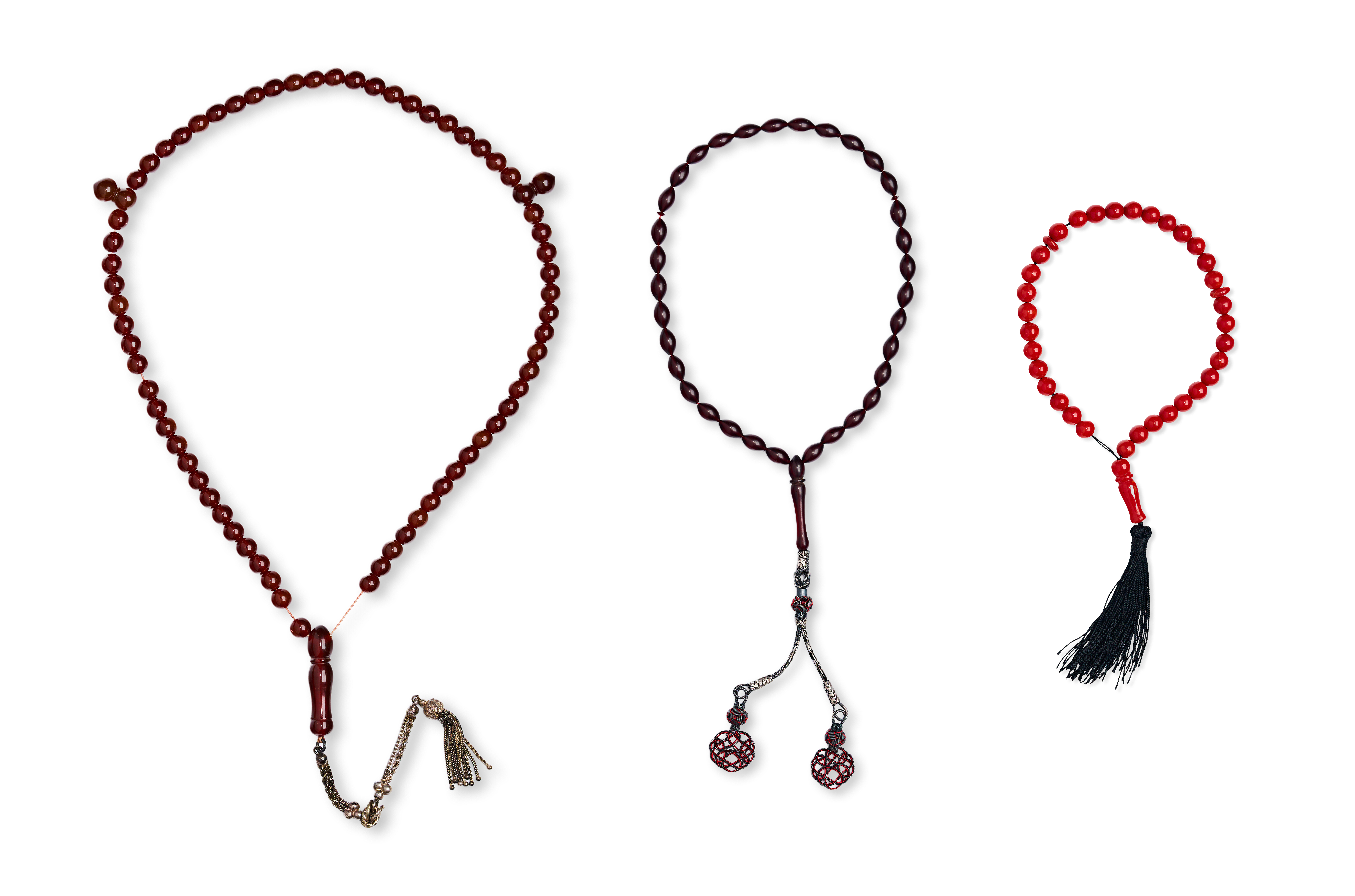 THREE ISLAMIC PRAYER BEAD SETS IN VARIOUS MATERIALS, CORAL AND BAKELITE