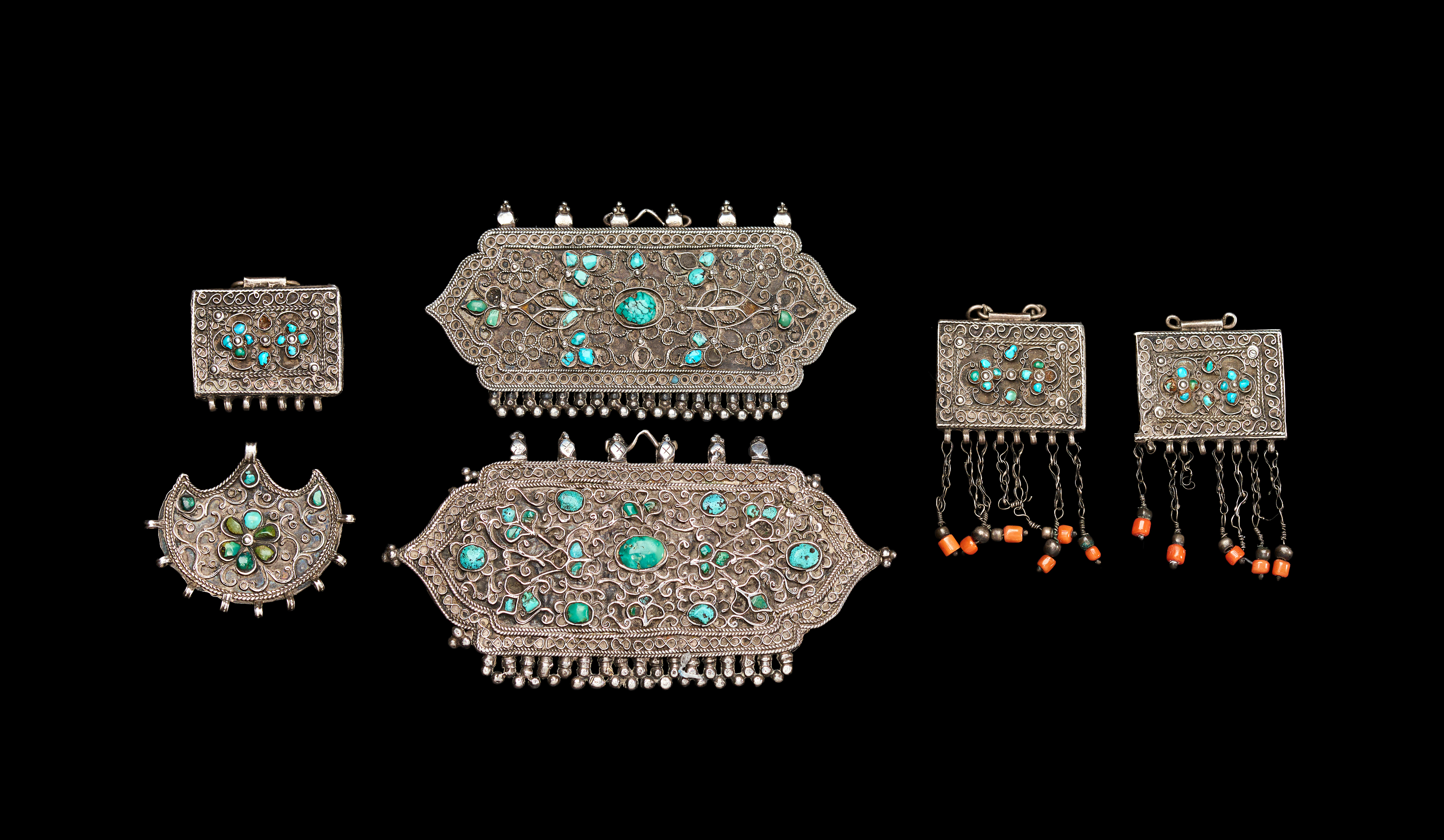 A GROUP OF BUKHARA SILVER AMULETS AND PENDANTS WITH TURQUOISE AND CORAL, 18TH - 19TH CENTURY