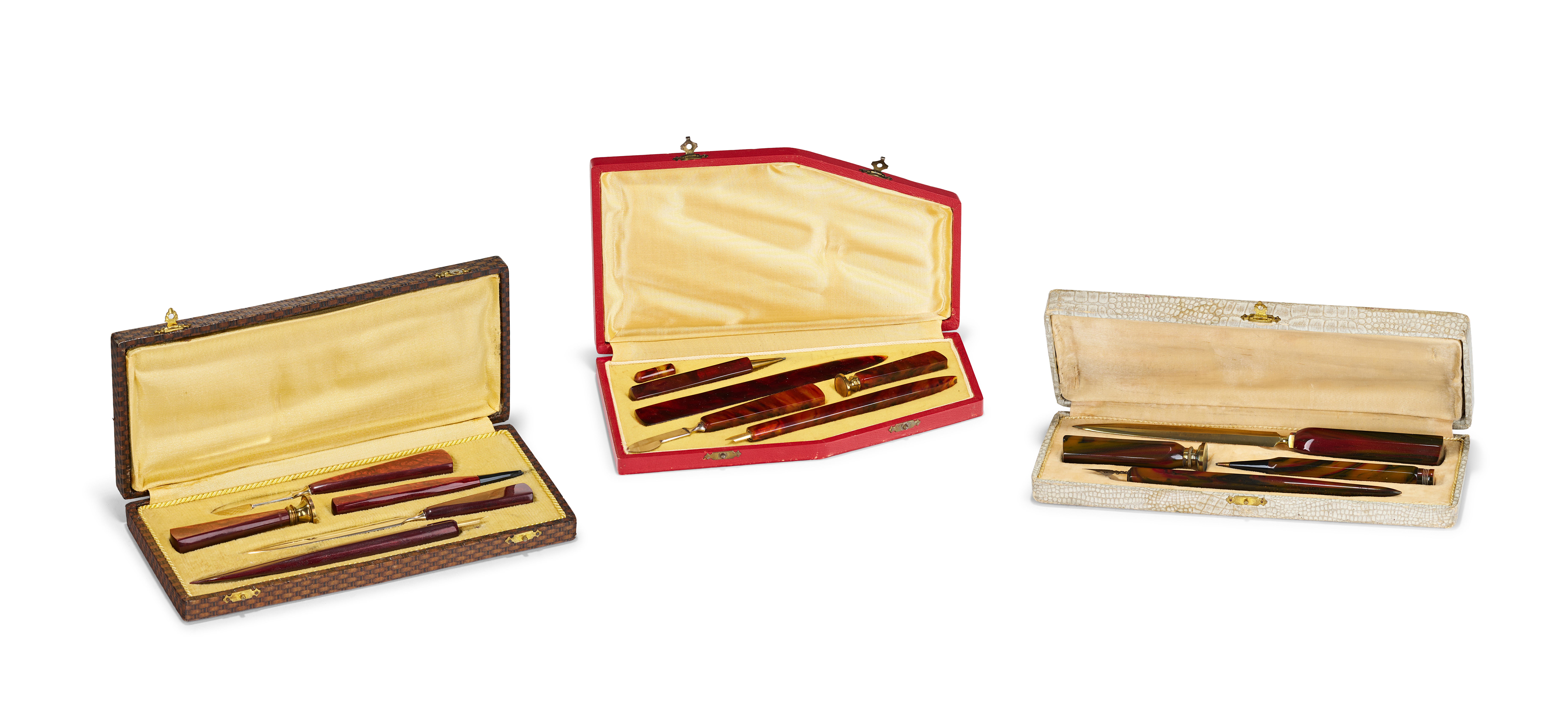 A COLLECTION OF ART DECO CASED CELLULOID DESK WRITING SETS WITH BAKELITE HANDLES
