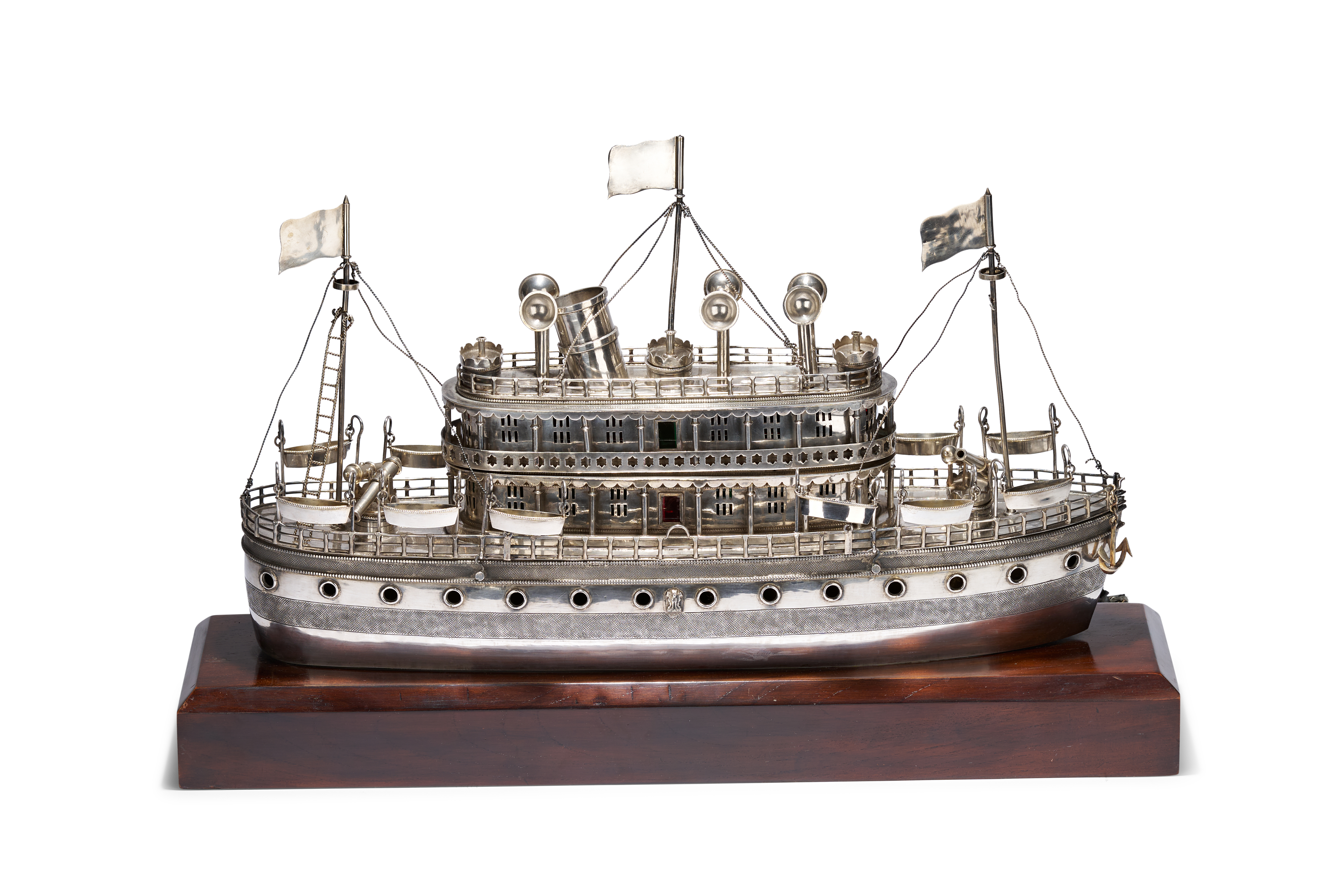 A LARGE INDIAN SILVER MODEL OF A MULTI-DECKED RIVER STEAMER OR GUNBOAT ON A HARDWOOD PLINTH