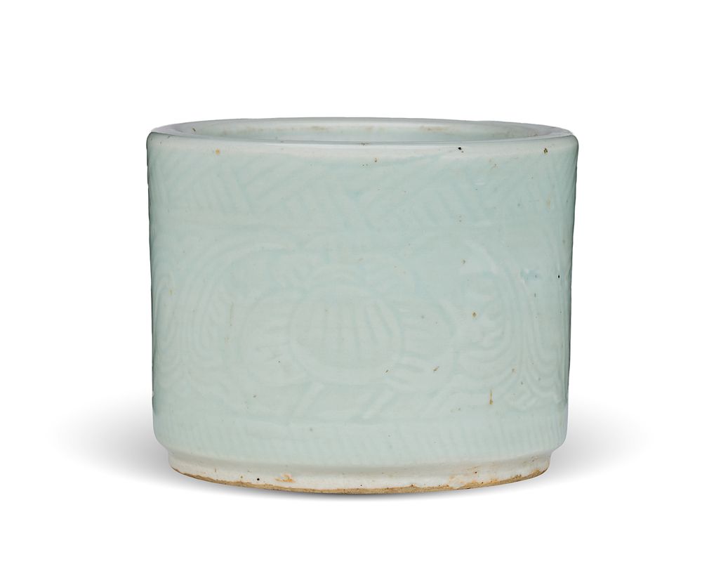 Lot 326: A CHINESE PALE CELADON-GLAZED CYLINDRICAL BRUSH POT