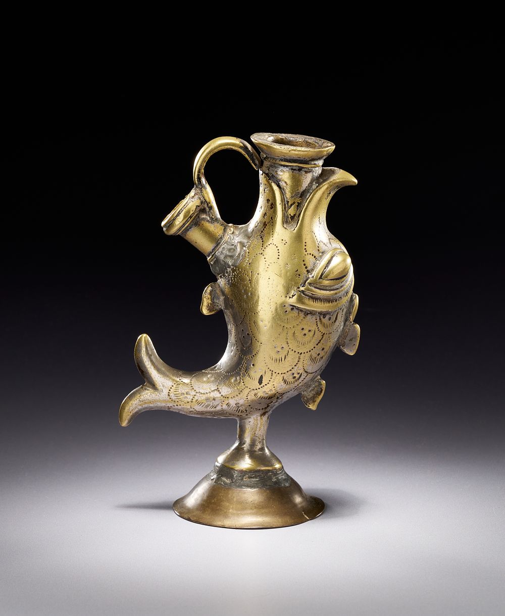 Lot 195: AN INDO-PERSIAN SILVERED BRASS ZOOMORPHIC VESSEL IN THE FORM OF A FISH