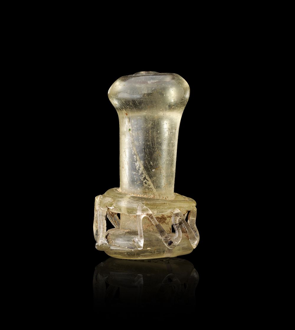 Lot 172: A SASANIAN OR EARLY ISLAMIC TRANSLUCENT GREEN GLASS CAGE-WORK SEAL