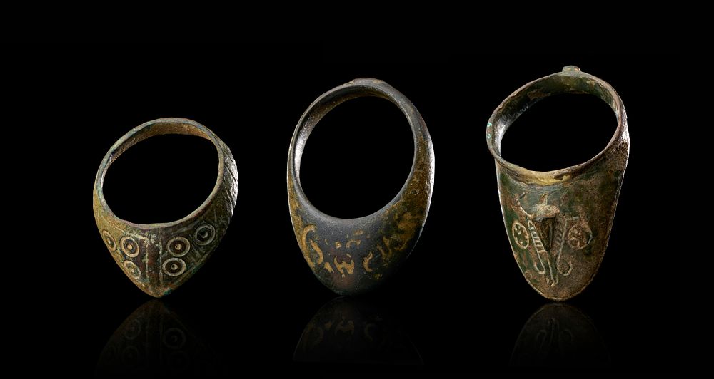 Lot 267: A TRIO OF ANTIQUE COPPER ALLOY ARCHERS THUMB RINGS, 13TH - 14TH CENTURY
