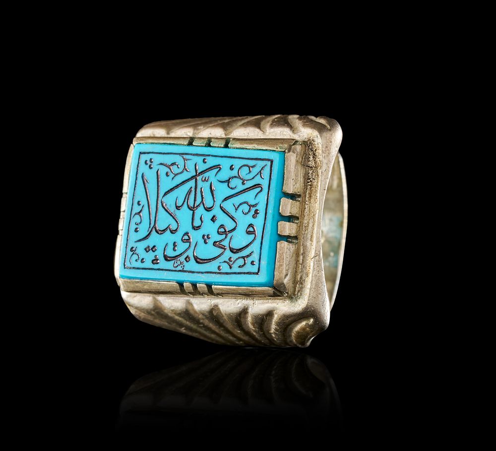 Lot 275: AN INSCRIBED ISLAMIC TALISMAN TURQUOISE-COLOURED STONE IN A SILVER RING