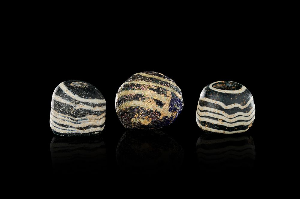 Lot 164: A TRIO OF MARVERED GLASS GAMING PIECES, AYYUBID OR MAMLUK, 12TH-13TH CENTURY
