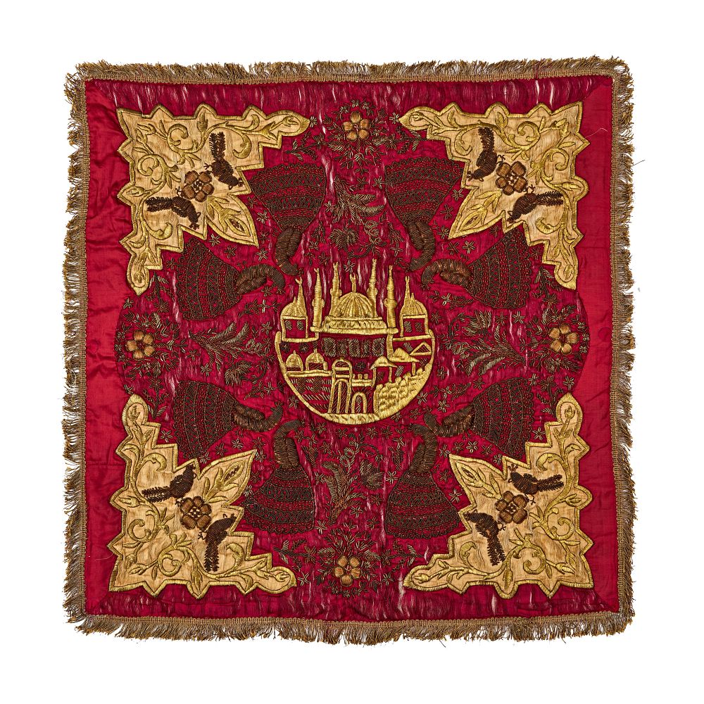 Lot 361: A LATE OTTOMAN EMBROIDERED RED SILK TEXTILE PANEL WITH ARCHITECTURAL MEDALLION, TURKEY, 19TH CENTURY