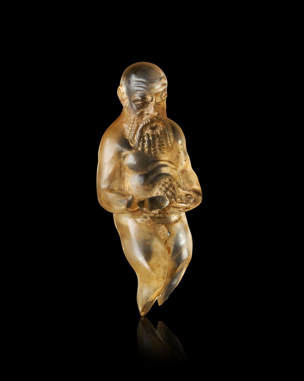 Lot 334: A RARE ROMAN CARVED QUARTZ FIGURINE OF A BEARDED MAN, 2ND - 3RD CENTURY A.D.
