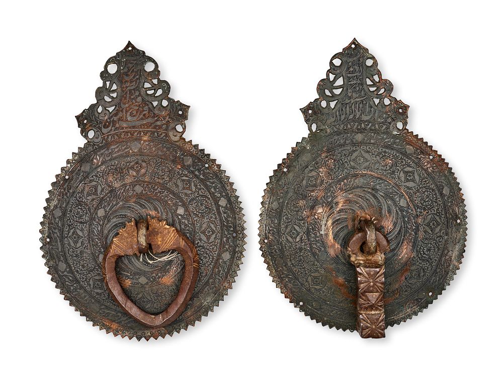 Lot 181: A PAIR OF PERSIAN CALLIGRAPHIC COPPER ALLOY DOOR KNOCKERS, LATE SAFAVID - EARLY QAJAR, 18TH - 19TH CENTURY