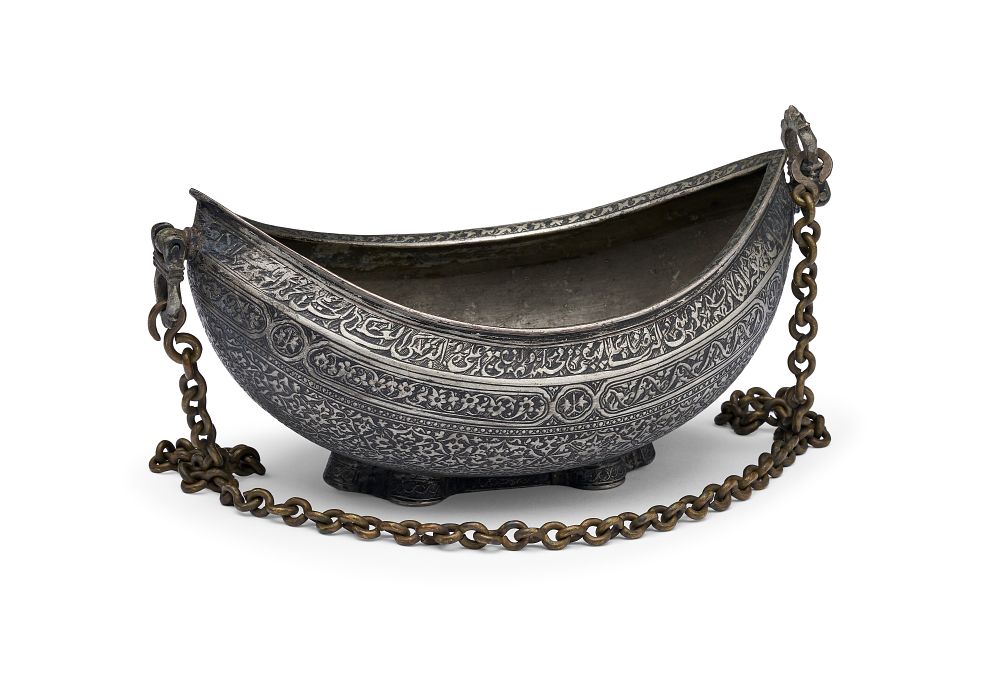 Lot 252: A QAJAR TINNED-COPPER KASHKUL BEGGARS BOWL WITH DRAGON HEAD TERMINALS, 18TH - 19TH CENTURY