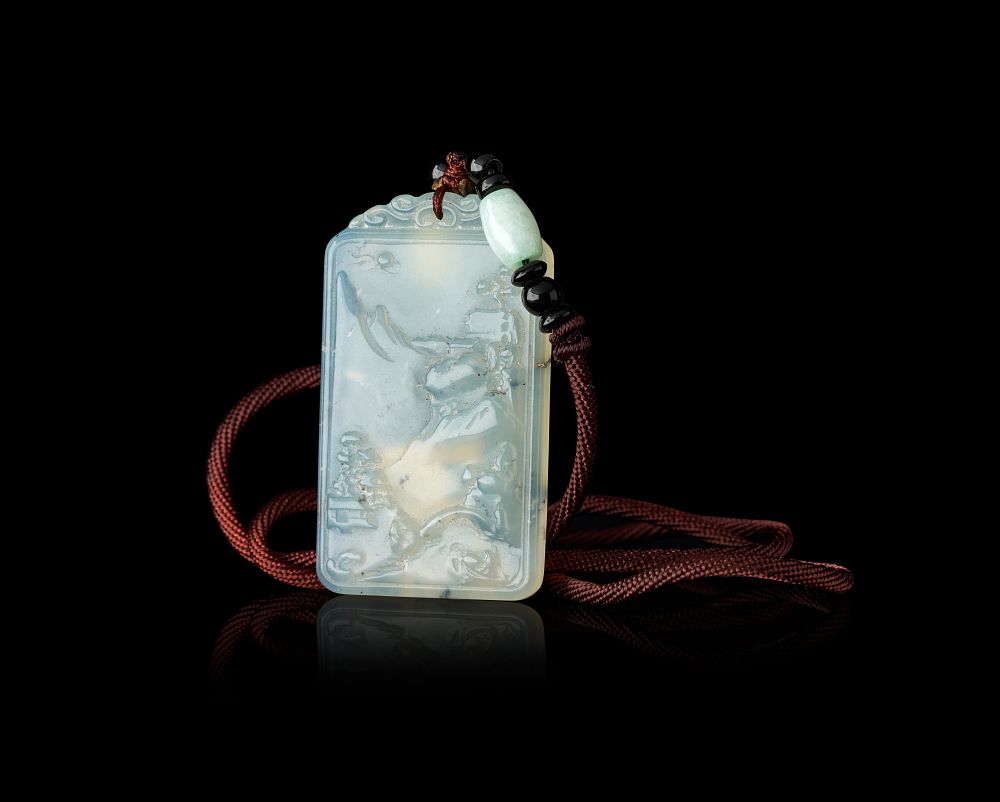 Lot 344: A CHINESE CARVED JADE LANDSCAPE PLAQUE PENDANT ON A BEADED SILK CORD