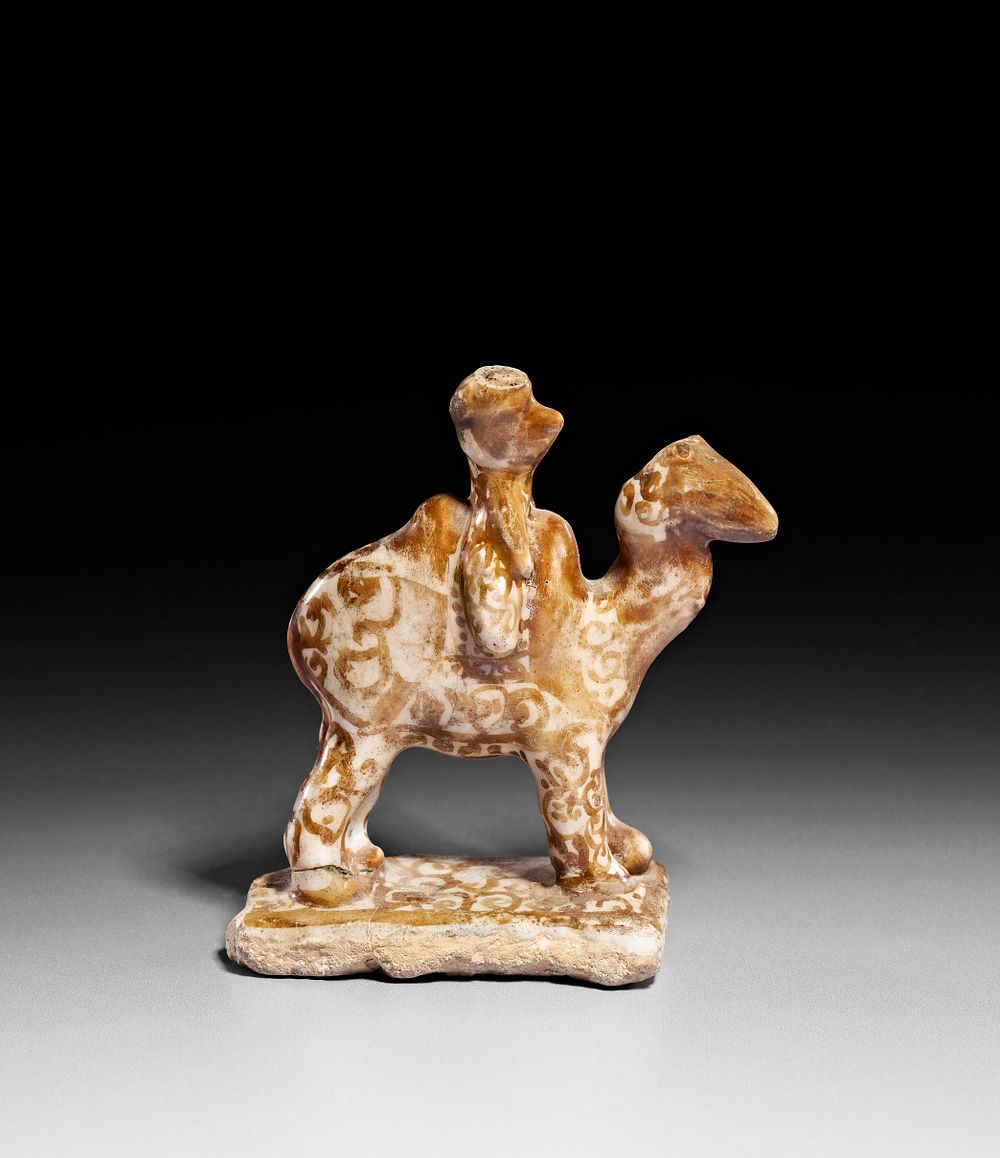 Lot 152: A KASHAN LUSTRE POTTERY FIGURE OF A BACTRIAN CAMEL AND RIDER, PERSIA, 12TH CENTURY