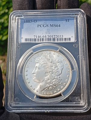 דולר כסף Morgan שנת 1883-O בדירוג MS64 PCGS. מטבע לא מסחרי עשוי מכסף 90% והוטבע בניו אורלינס 
